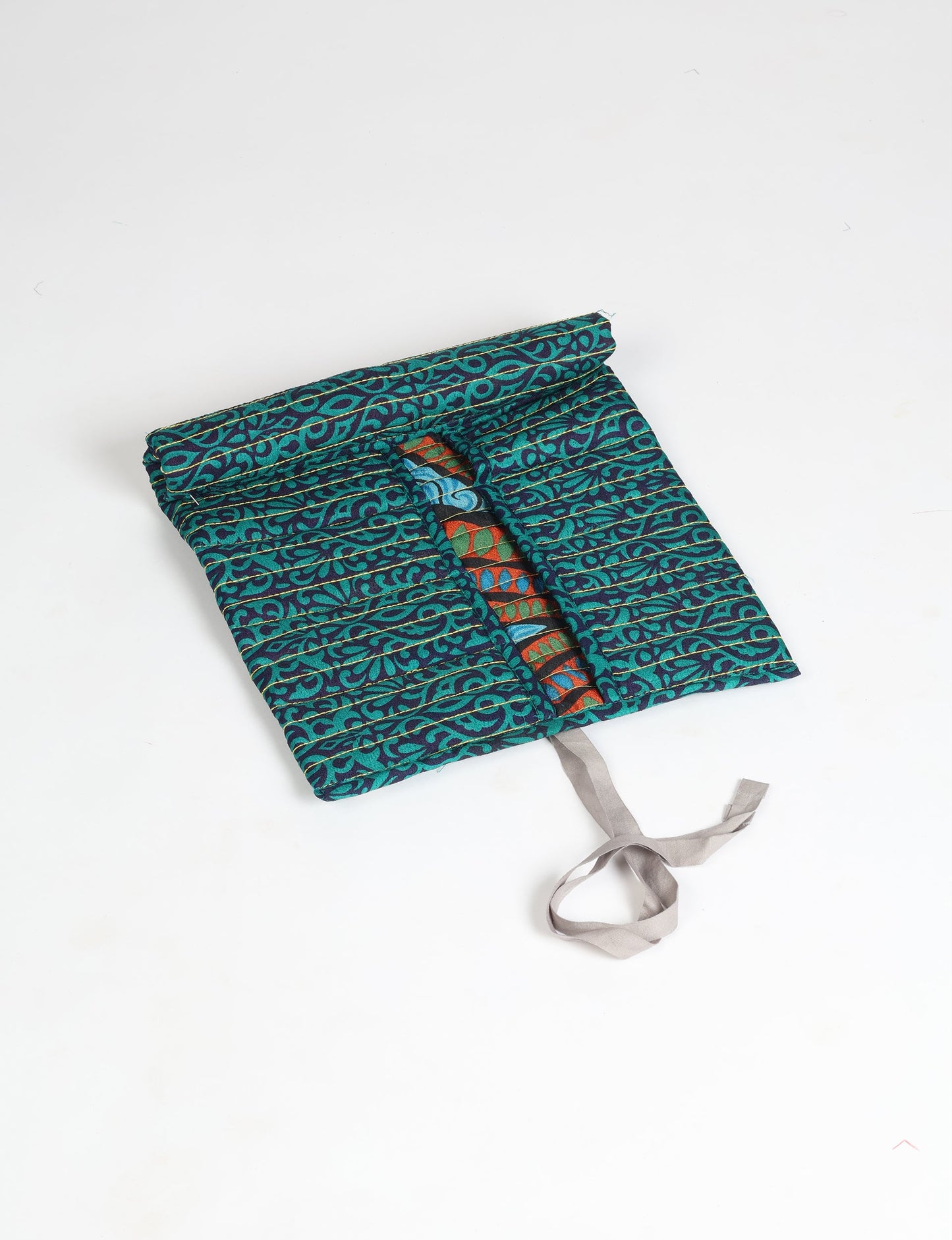 Roll-Up Organizer made from repurposed sari fabric, showcasing compact design and sustainable fashion innovation.