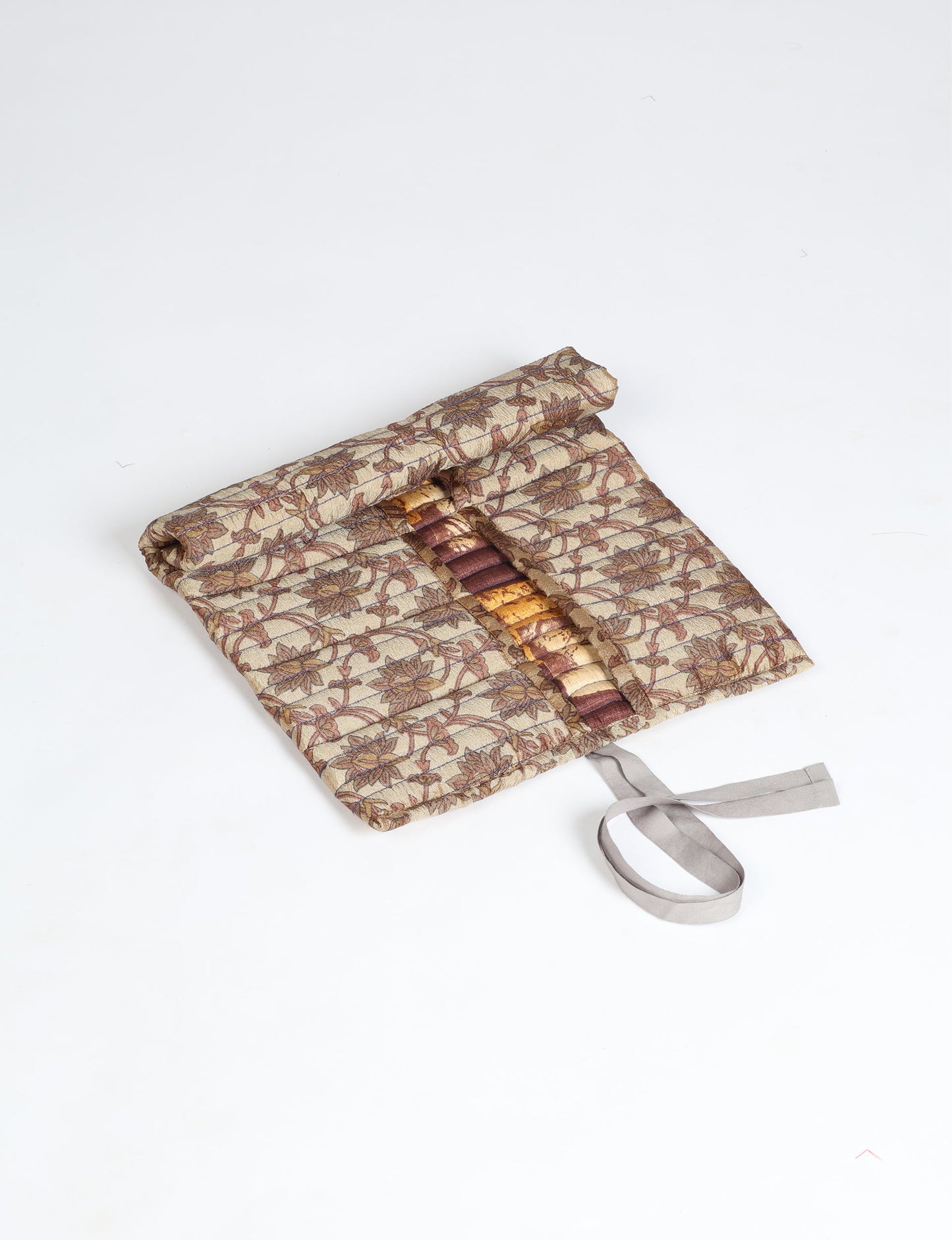 Roll-Up Organizer made from repurposed sari fabric, showcasing compact design and sustainable fashion innovation.
