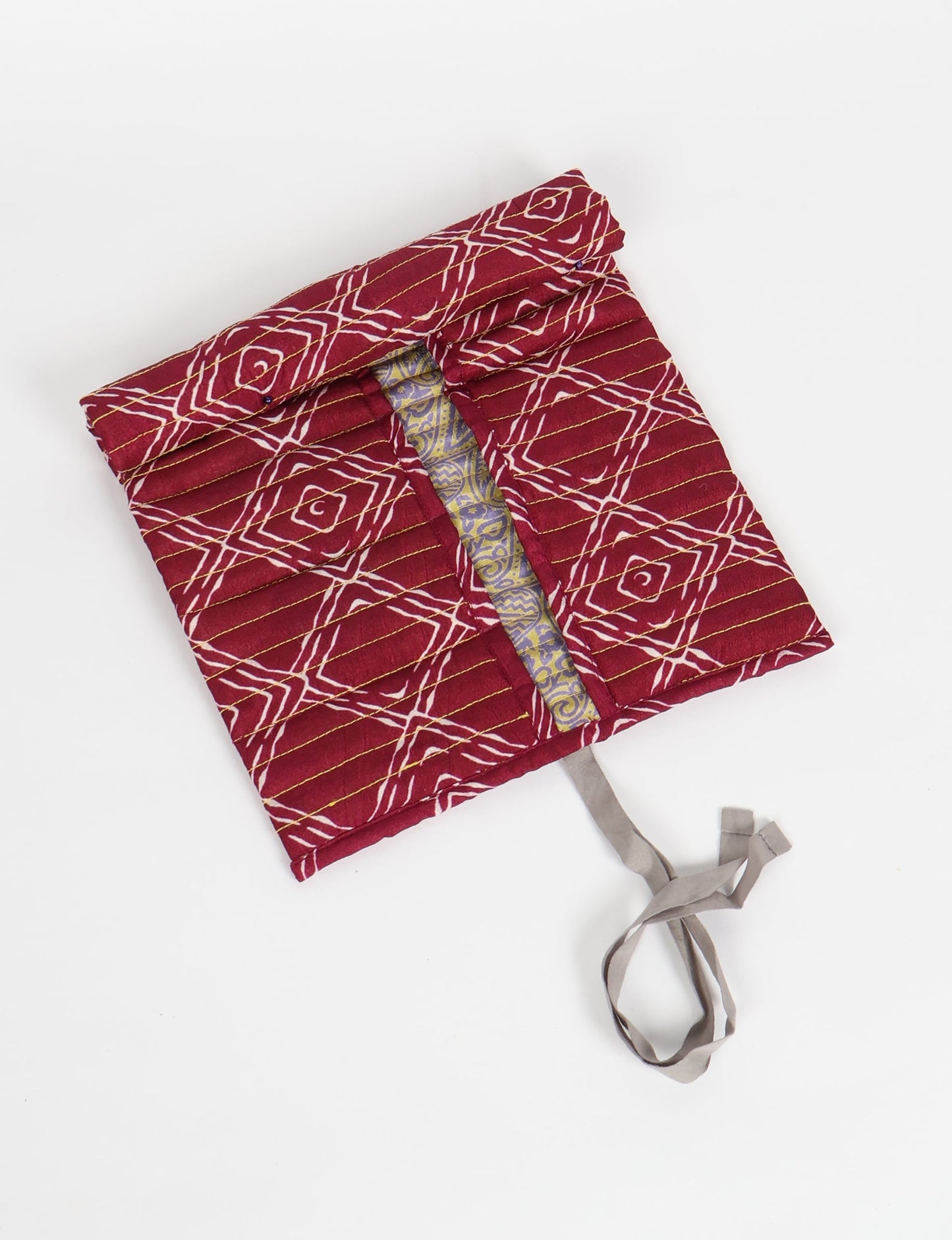 Roll-Up Organizer made from repurposed sari fabric, showcasing compact design and sustainable fashion innovation.