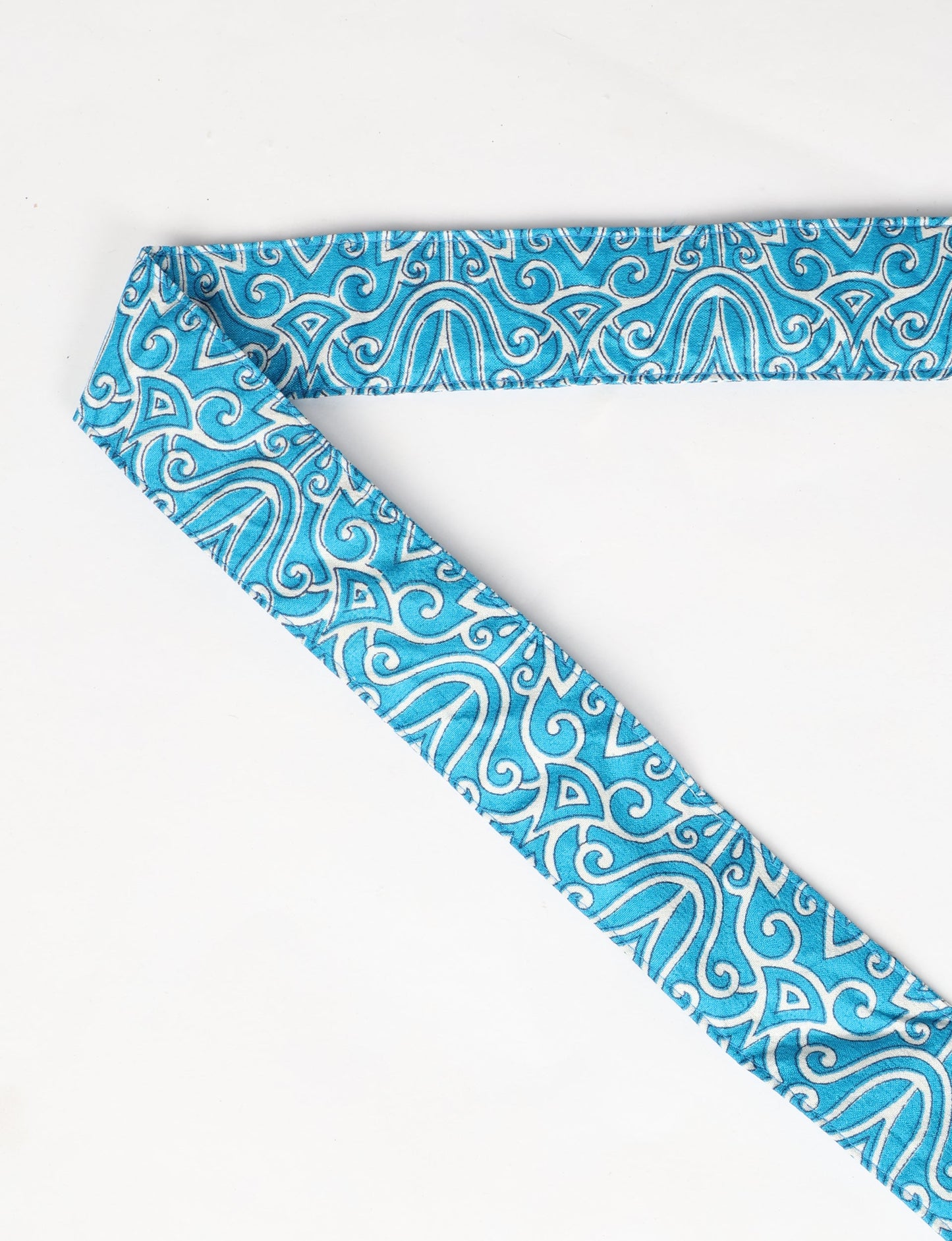 A green yoga mat holder made from upcycled materials, embodying ethical and sustainable fashion ideals.