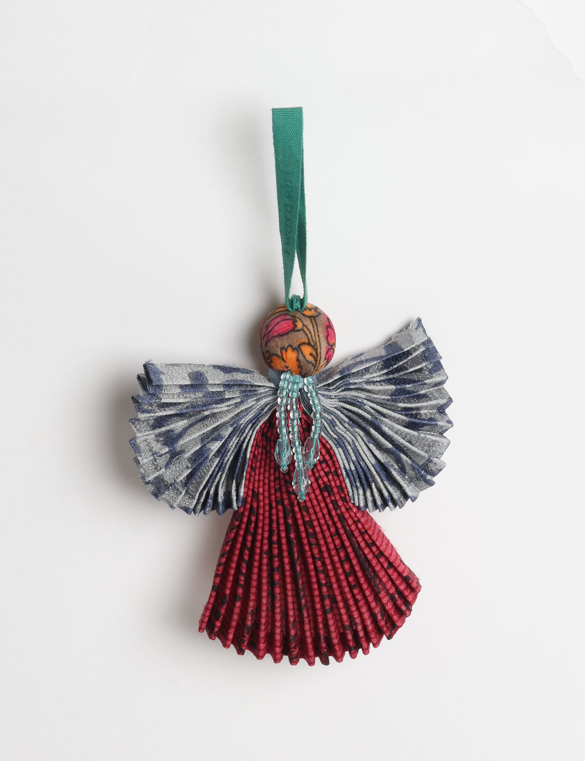 Angel Christmas Ornament made from upcycled saris, featuring pleated arms and body. A sustainable, eco-friendly holiday decoration, embodying recycled fashion and upcycling in festive style.