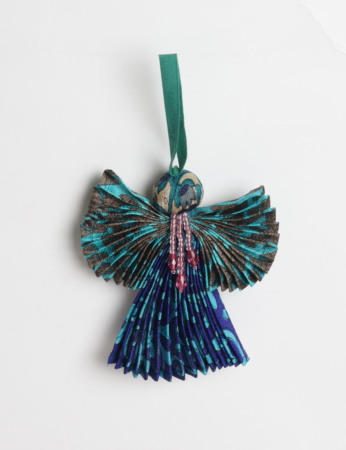 Angel Christmas Ornament made from upcycled saris, featuring pleated arms and body. A sustainable, eco-friendly holiday decoration, embodying recycled fashion and upcycling in festive style.