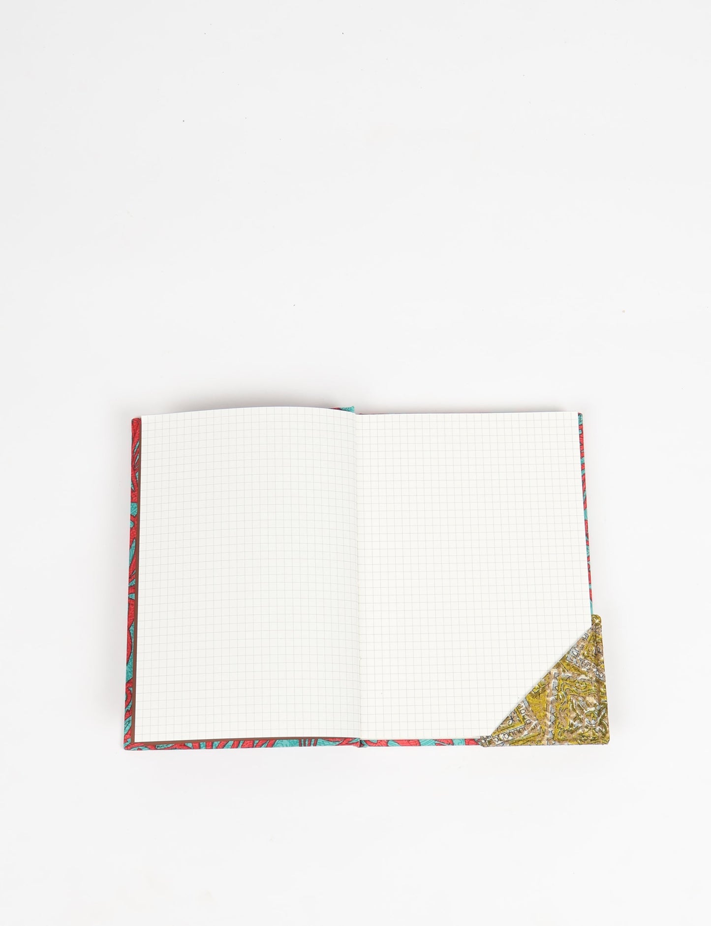 Colorful square-shaped corner bookmark made from recycled sari textiles, representing repurposed clothing, fair trade fashion, and ethical fashion. An earth-friendly product made from textile waste, aligning with carbon neutral clothing values.