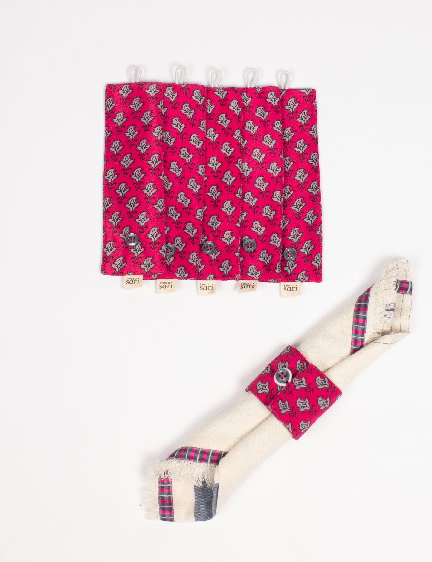 A set of 6 napkin rings made from repurposed saris, showcasing the beauty of sustainable fashion and upcycled materials. These stylish, eco-friendly rings with button closures are ideal for adding a touch of environmentally conscious elegance to your dining table.