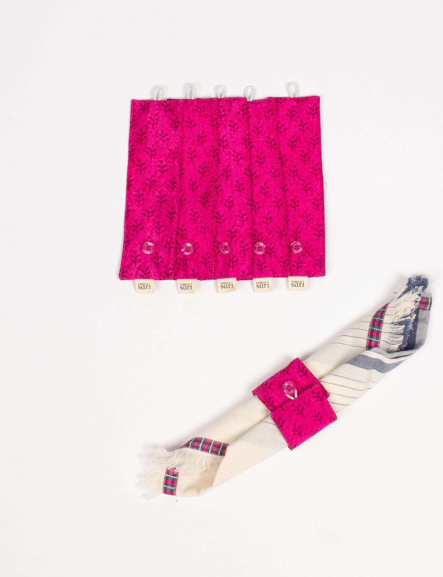 A set of 6 napkin rings made from repurposed saris, showcasing the beauty of sustainable fashion and upcycled materials. These stylish, eco-friendly rings with button closures are ideal for adding a touch of environmentally conscious elegance to your dining table.