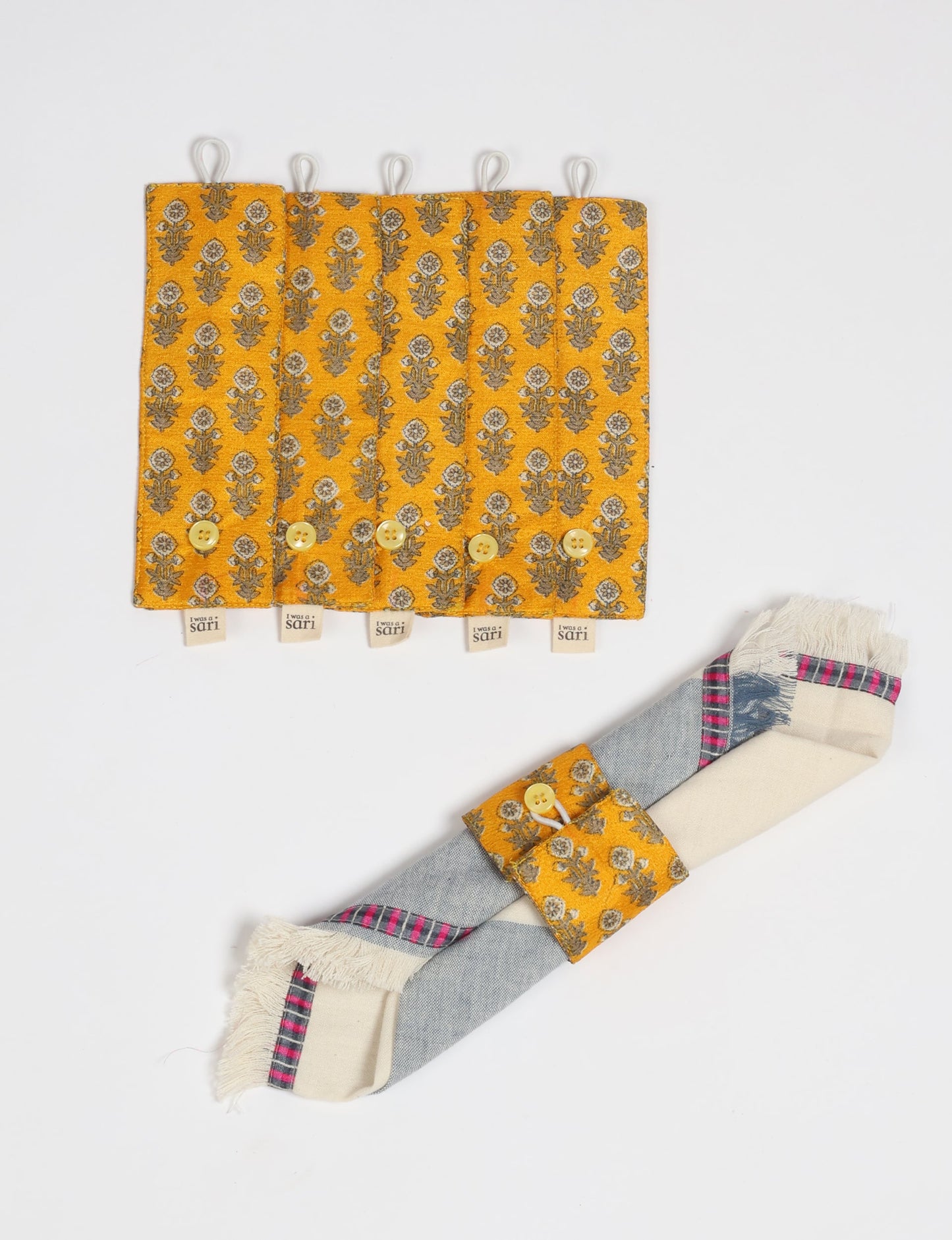 A set of 6 napkin rings made from repurposed saris, showcasing the beauty of sustainable fashion and upcycled materials. These stylish, eco-friendly rings with button closures are ideal for adding a touch of environmentally conscious elegance to your dining table.