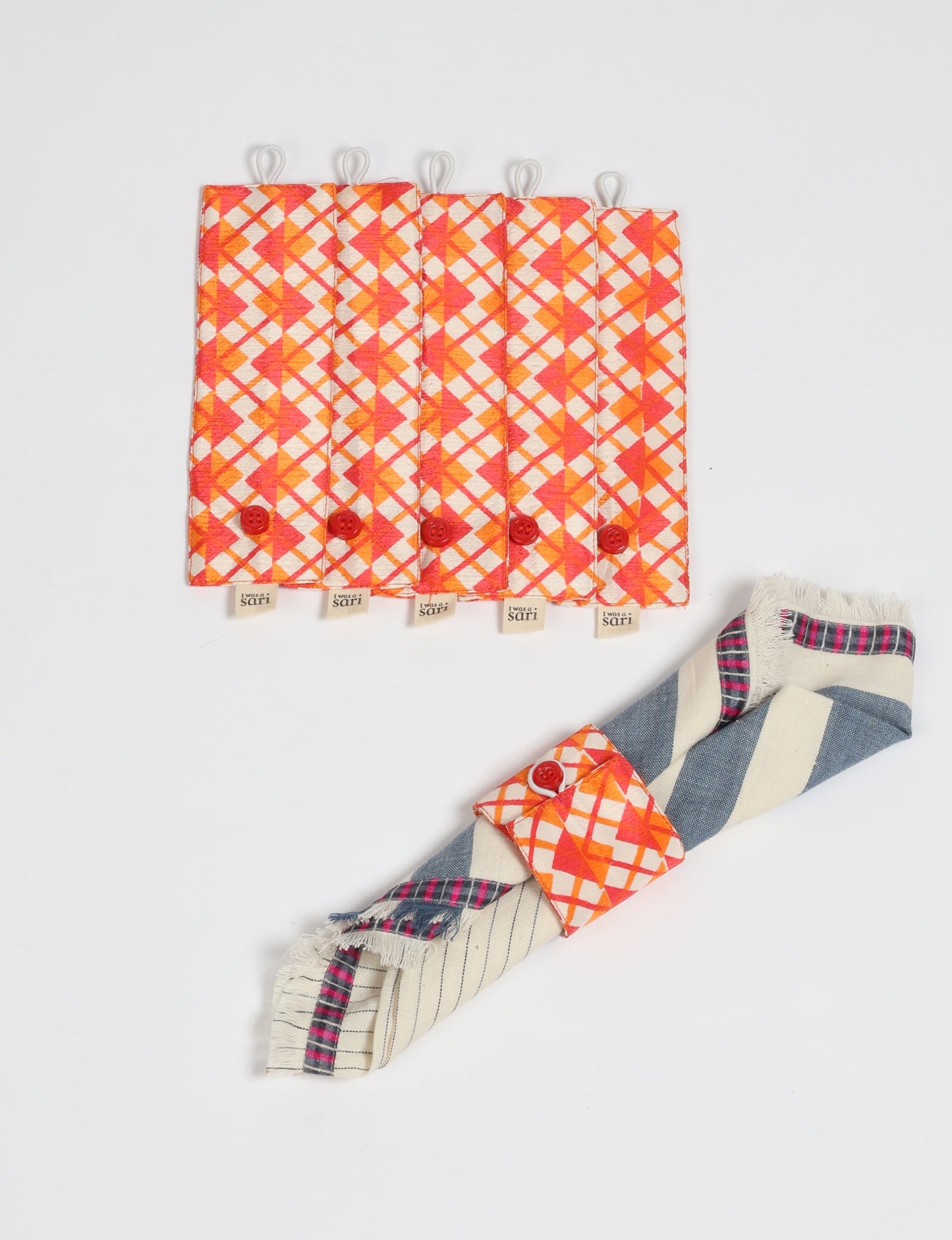 A set of 6 napkin rings made from repurposed saris, showcasing the beauty of sustainable fashion and upcycled materials. These stylish, eco-friendly rings with button closures are ideal for adding a touch of environmentally conscious elegance to your dining table.