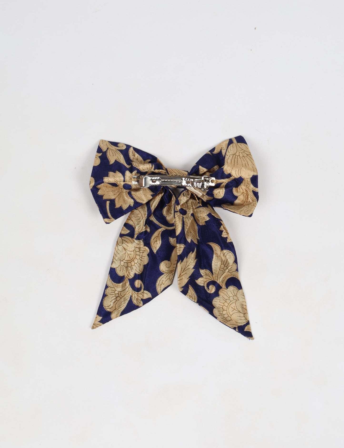 Colorful upcycled women's bow hairclip made from eco friendly cloth, reflecting ethical clothing, circular fashion, and environment friendly clothing—ideal for supporters of green fashion and natural clothing.