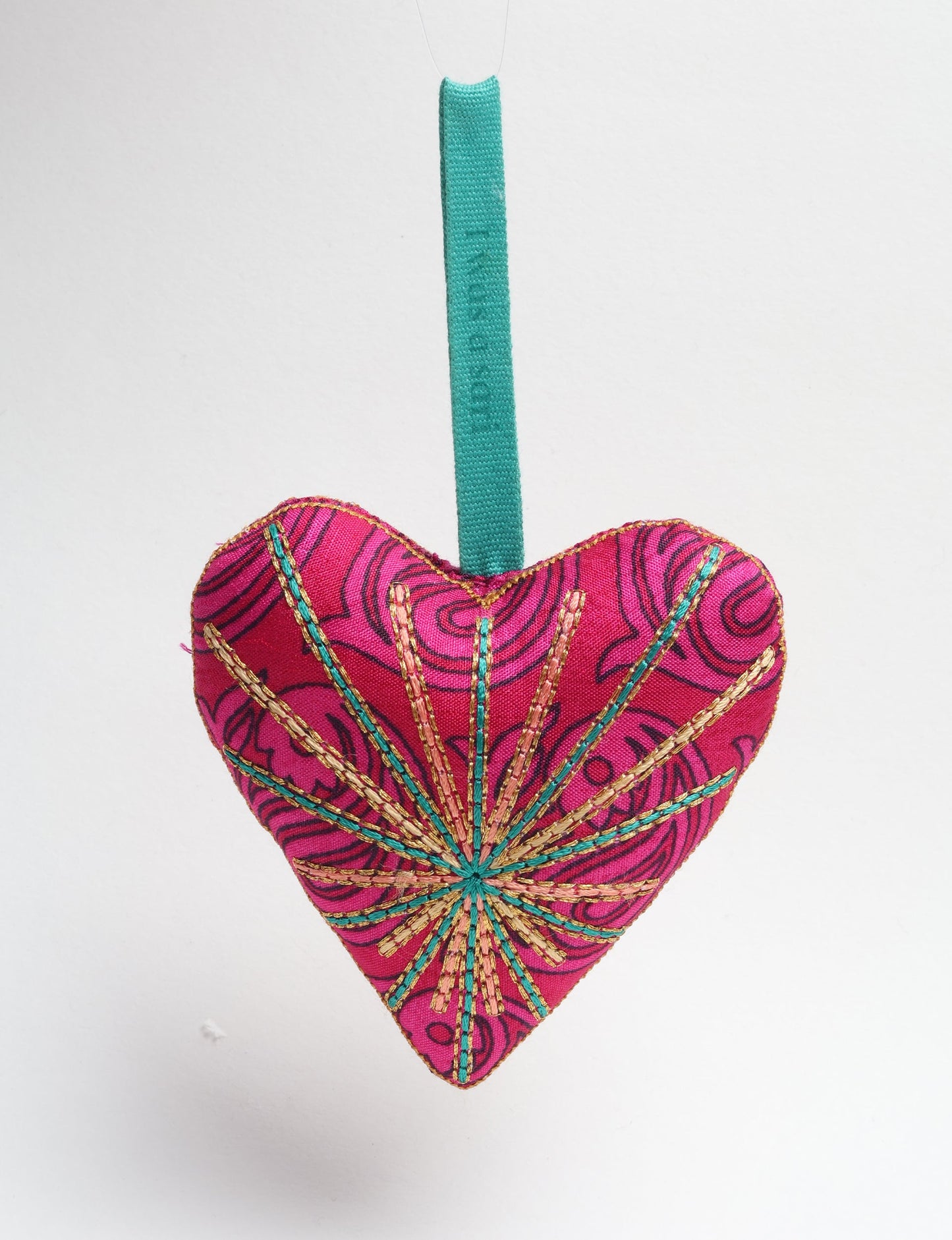 Timeless Heart ornament made from upcycled clothing and recycled fabric, filled with organic cotton and hand-finished with vibrant silk and metallic thread. An eco-friendly, carbon neutral fashion piece that supports green fashion and fair trade apparel.