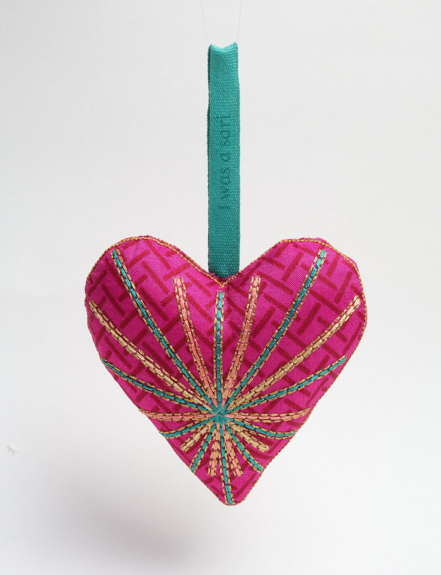 Timeless Heart ornament made from upcycled clothing and recycled fabric, filled with organic cotton and hand-finished with vibrant silk and metallic thread. An eco-friendly, carbon neutral fashion piece that supports green fashion and fair trade apparel.