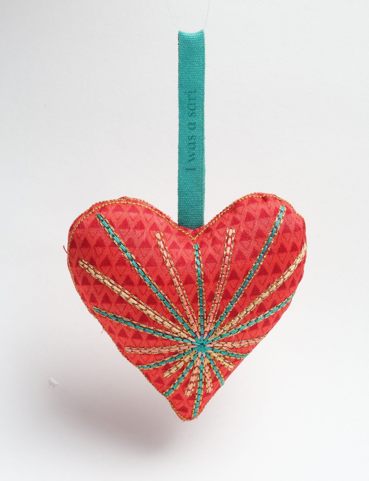 Timeless Heart ornament made from upcycled clothing and recycled fabric, filled with organic cotton and hand-finished with vibrant silk and metallic thread. An eco-friendly, carbon neutral fashion piece that supports green fashion and fair trade apparel.