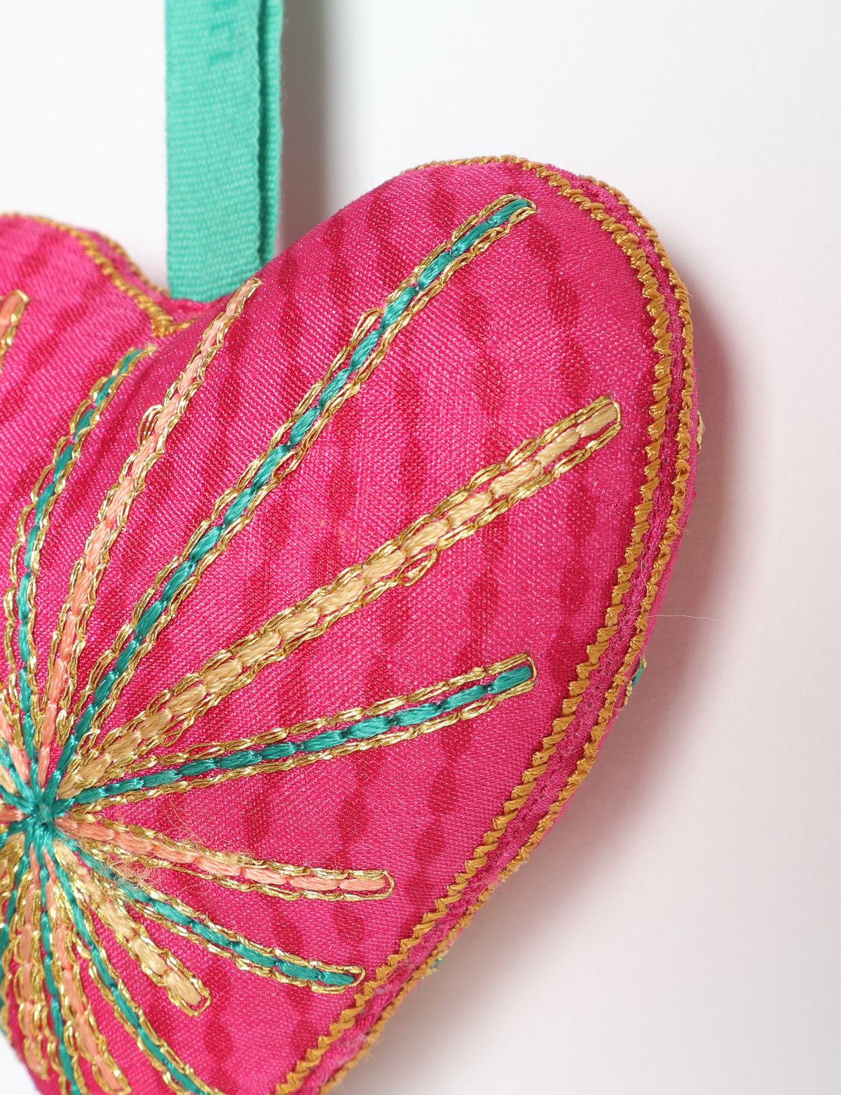 Timeless Heart ornament made from upcycled clothing and recycled fabric, filled with organic cotton and hand-finished with vibrant silk and metallic thread. An eco-friendly, carbon neutral fashion piece that supports green fashion and fair trade apparel.