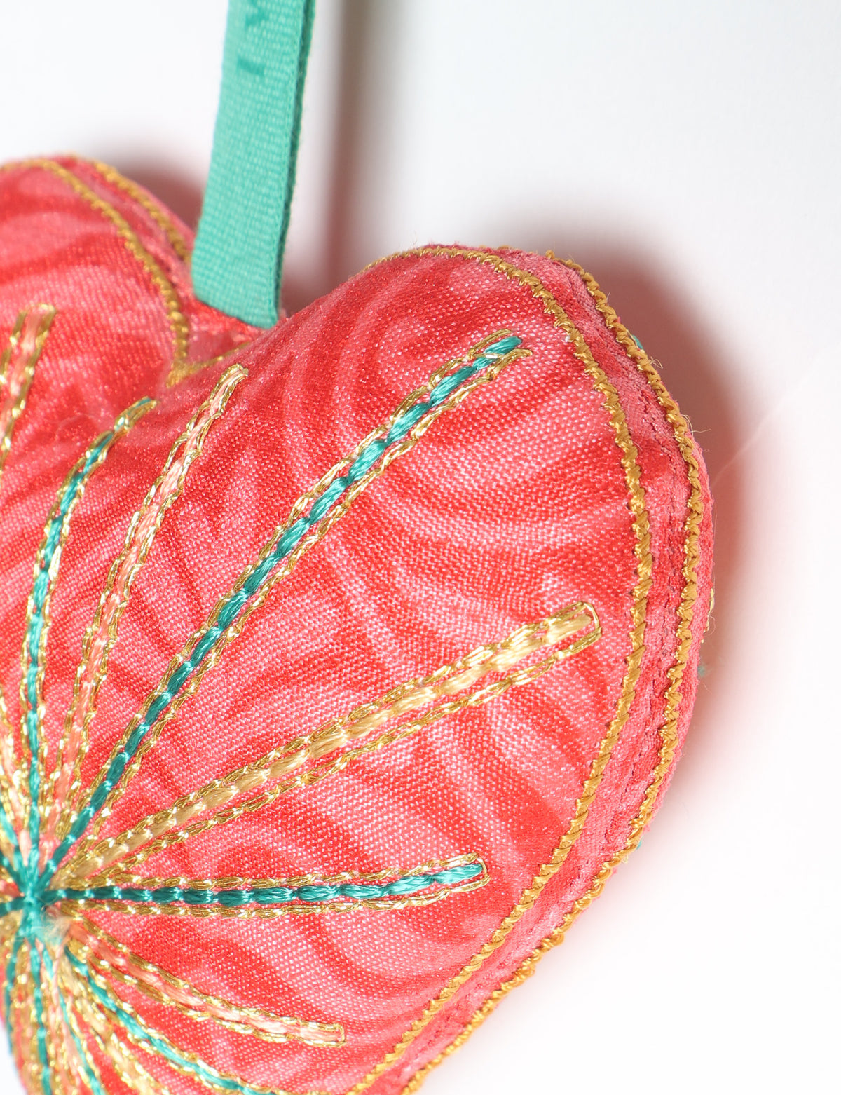 Timeless Heart ornament made from upcycled clothing and recycled fabric, filled with organic cotton and hand-finished with vibrant silk and metallic thread. An eco-friendly, carbon neutral fashion piece that supports green fashion and fair trade apparel.