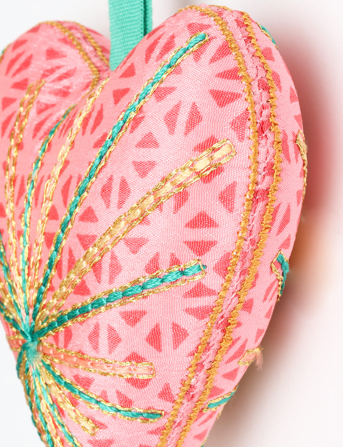Timeless Heart ornament made from upcycled clothing and recycled fabric, filled with organic cotton and hand-finished with vibrant silk and metallic thread. An eco-friendly, carbon neutral fashion piece that supports green fashion and fair trade apparel.