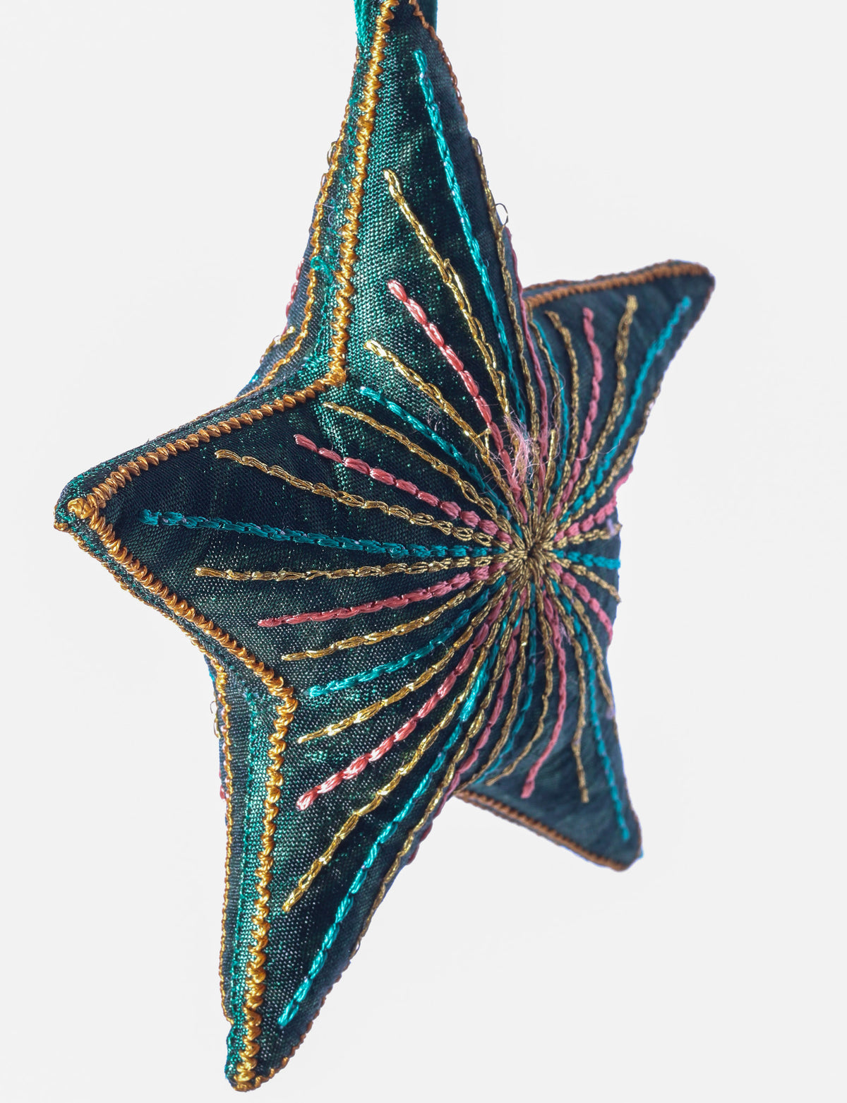 Timeless star ornament made from recycled sari fabric, featuring silk and metallic embroidery, crafted as part of green fashion, recycled clothing design, environmentally friendly clothing practices, and repurposed clothing traditions.