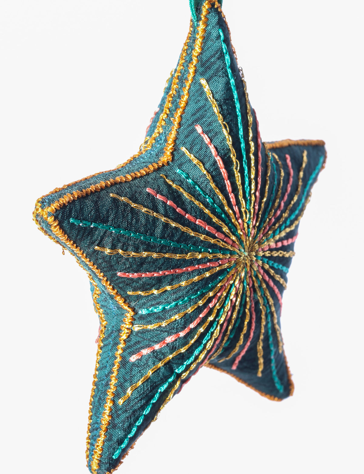 Timeless star ornament made from recycled sari fabric, featuring silk and metallic embroidery, crafted as part of green fashion, recycled clothing design, environmentally friendly clothing practices, and repurposed clothing traditions.