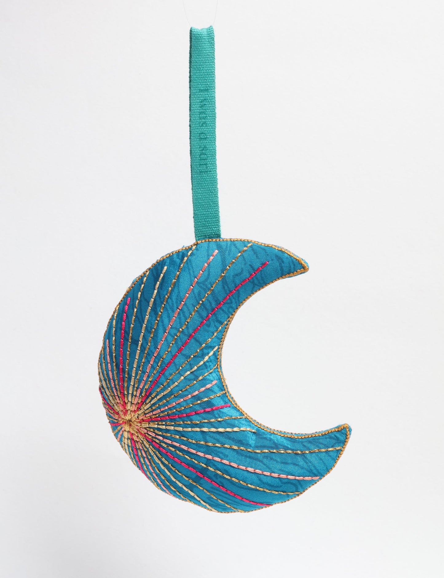 Timeless crescent moon ornament made from recycled materials and textile waste, featuring intricate embroidery. A zero waste and carbon offset accessory that supports circular fashion, fair trade fashion, and environmentally friendly clothing choices.