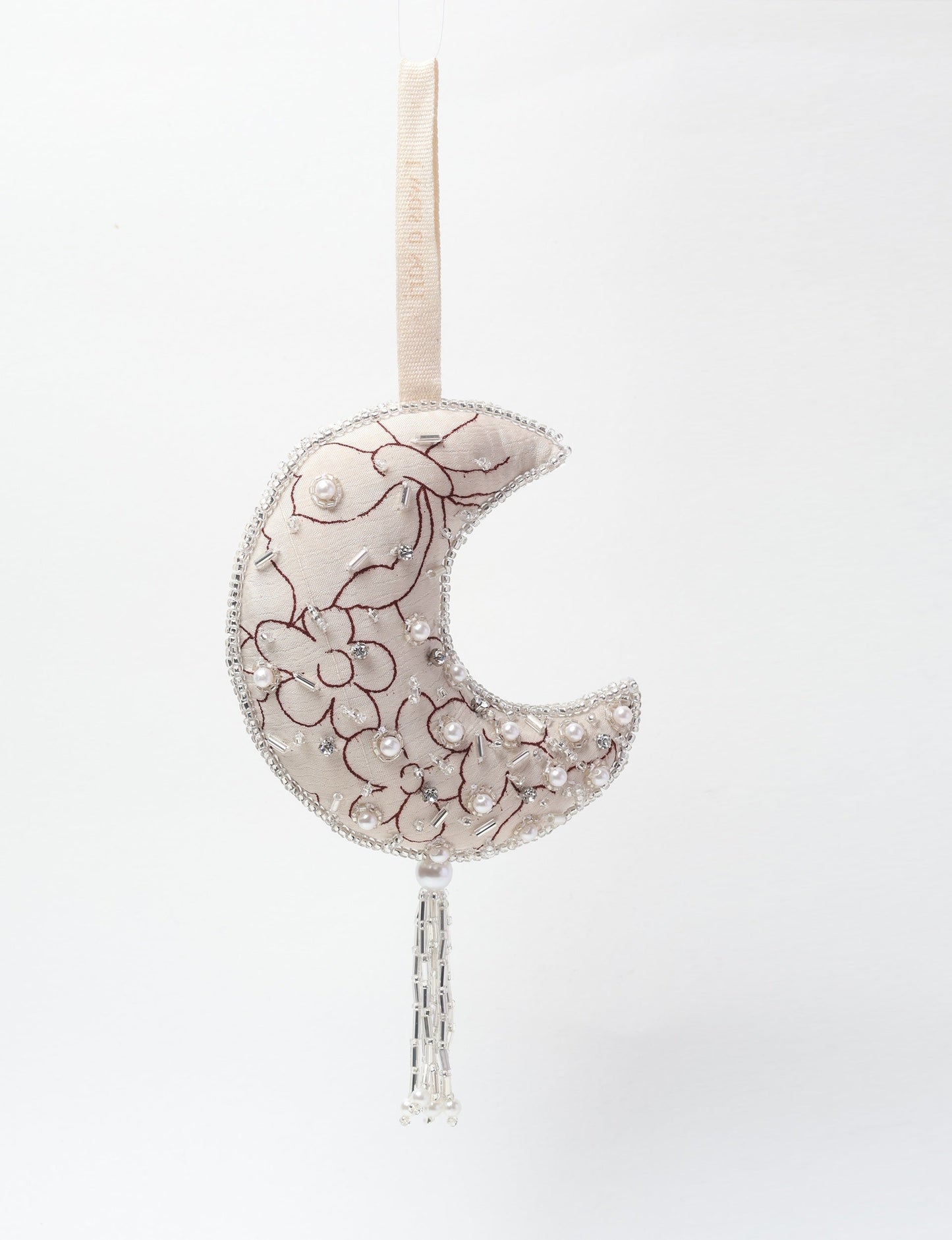 Crescent moon ornament made from recycled clothing, featuring fair trade fashion, clothes made from recycled fabric, and upcycled garments with elegant silver embellishments and tassel, ideal for those who value climate neutral clothing and recycled sustainable fashion.