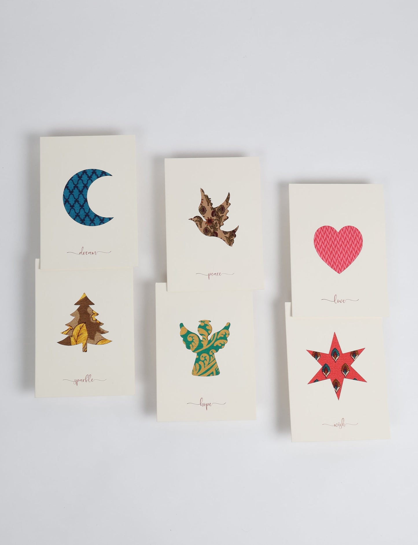 Folded greeting card set of 6 made from recycled sari scraps, symbolising Wish, Hope, Sparkle, Love, Peace, and Dream — beautifully designed with repurposed clothing textiles, upcycled garments, circular fashion inspiration, and fair trade fashion aesthetics, reflecting environmentally friendly clothing values.