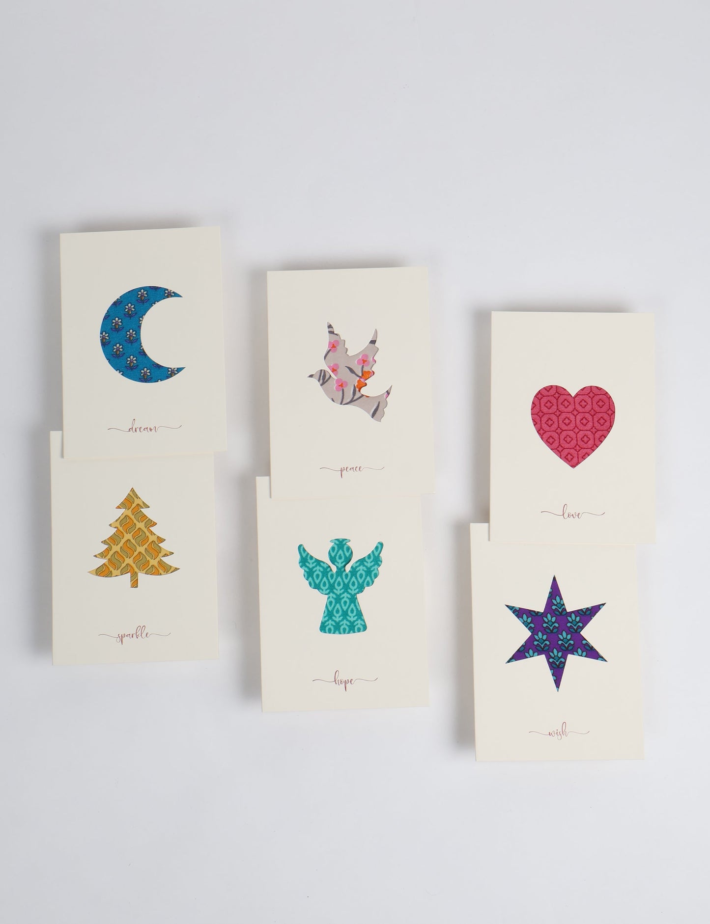 Folded greeting card set of 6 made from recycled sari scraps, symbolising Wish, Hope, Sparkle, Love, Peace, and Dream — beautifully designed with repurposed clothing textiles, upcycled garments, circular fashion inspiration, and fair trade fashion aesthetics, reflecting environmentally friendly clothing values.