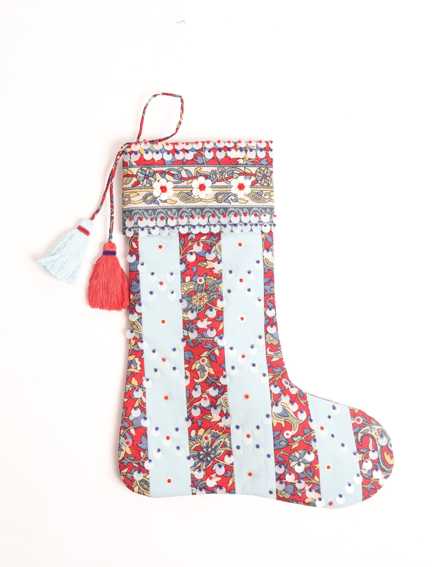 Upcycled sari Christmas stocking with striped cotton accents and hand-embroidered embellishments, reflecting green fashion, zero-waste clothing, recycled fashion, repurposed clothing, carbon-neutral fashion, natural clothing, conscious clothing, and sustainable women’s clothing.