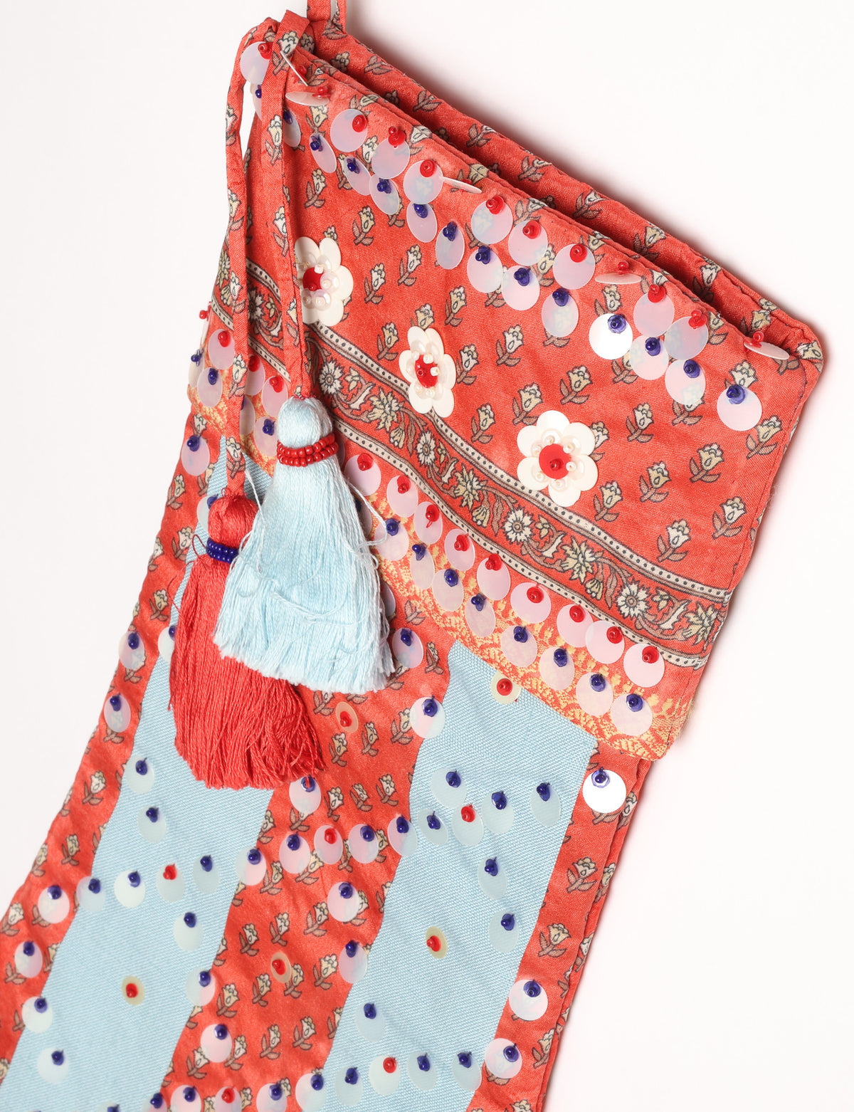 Upcycled sari Christmas stocking with striped cotton accents and hand-embroidered embellishments, reflecting green fashion, zero-waste clothing, recycled fashion, repurposed clothing, carbon-neutral fashion, natural clothing, conscious clothing, and sustainable women’s clothing.