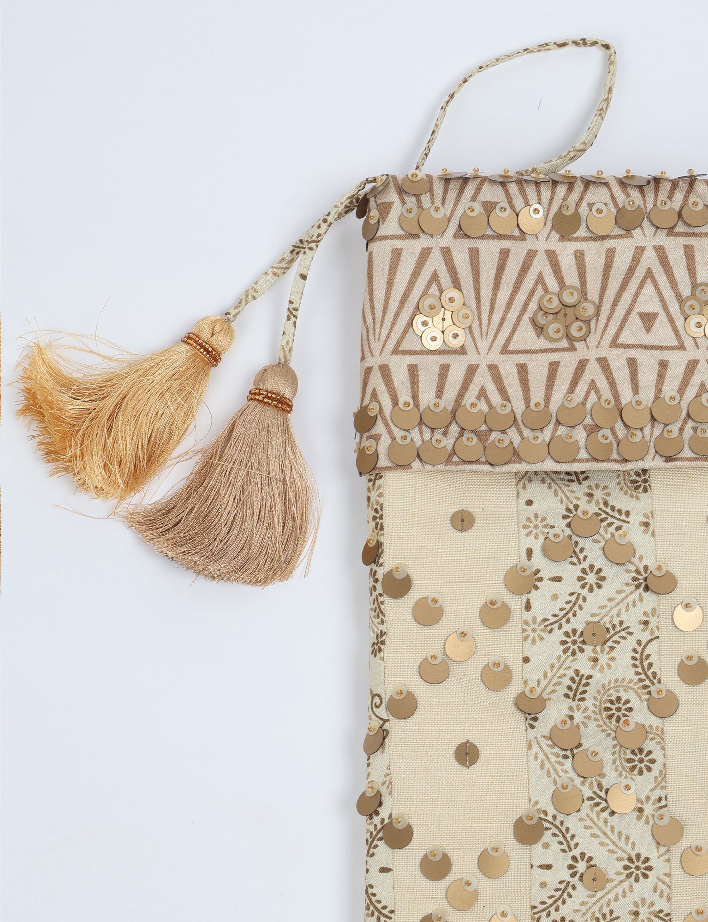 Upcycled sari Christmas stocking in ivory and cream tones with striped cotton detailing and gold embroidery; handmade eco clothing piece representing conscious clothing, recycled fashion, sustainable apparel, and fair trade fashion craftsmanship.