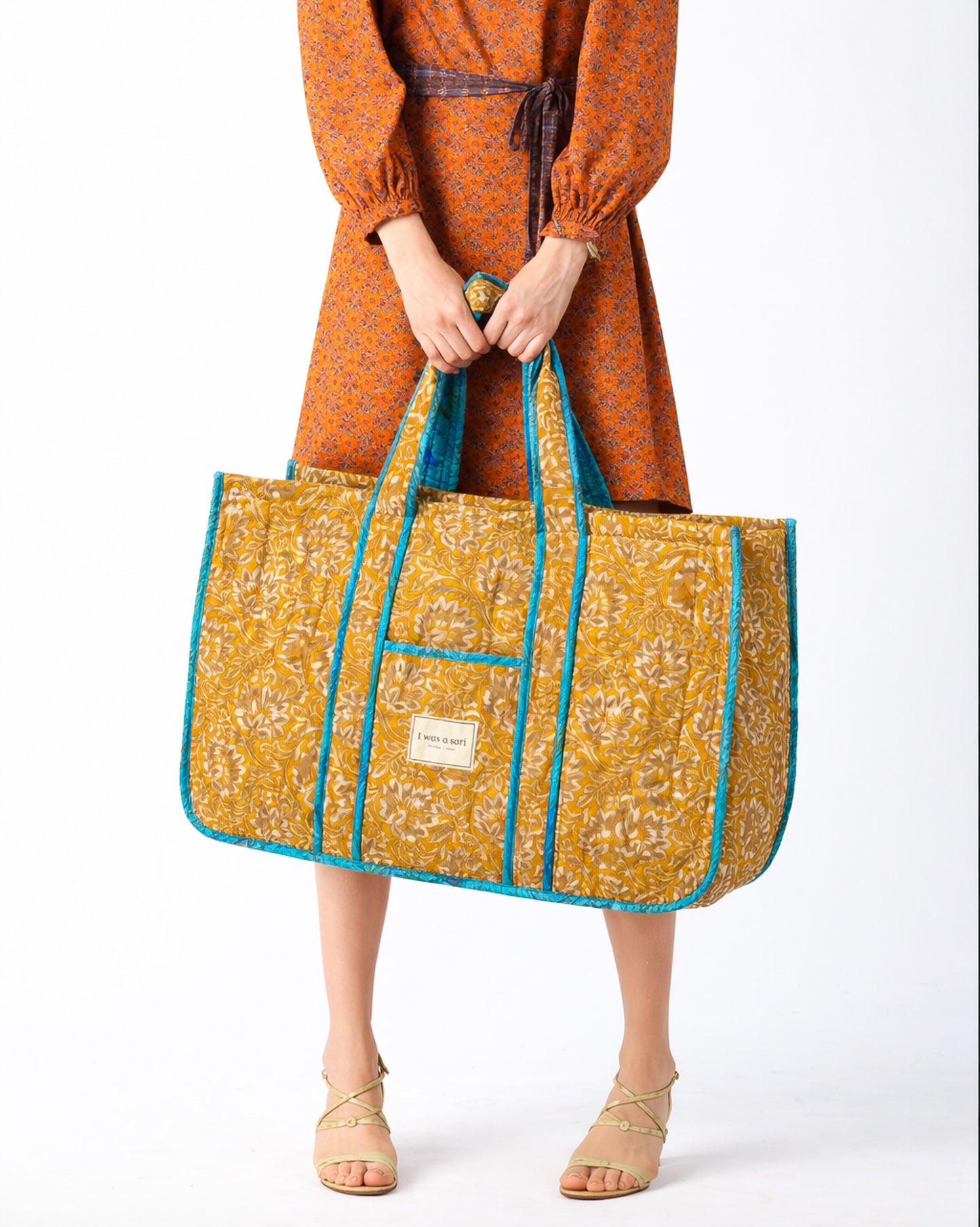 Quilted work tote bag with structured rectangular design and long shoulder straps, representing slow fashion and ethical clothing ideals, made as part of upcycled women's clothing and sustainable women's clothing using recycled fashion and earth friendly clothing practices.