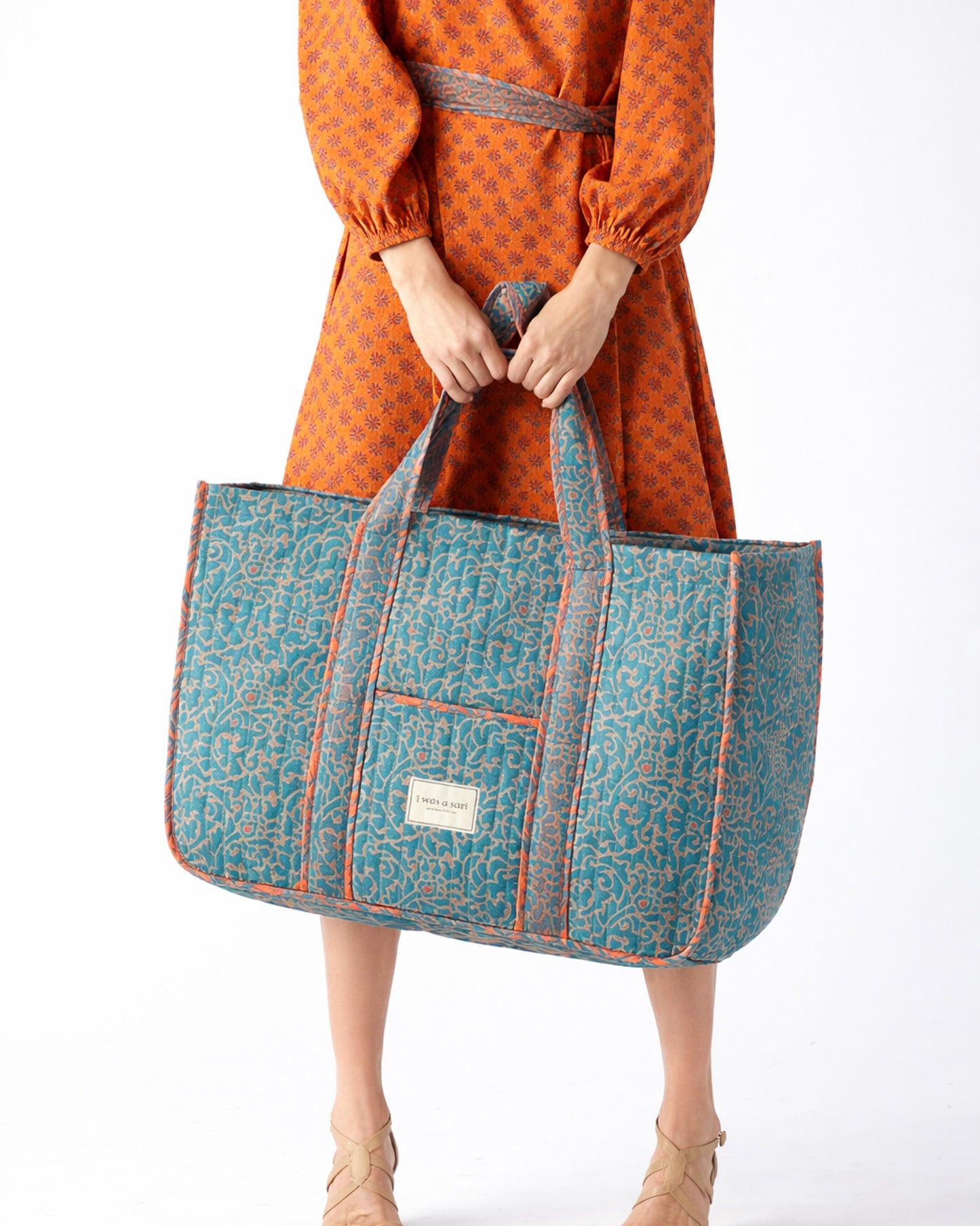 Quilted work tote bag with structured rectangular design and long shoulder straps, representing slow fashion and ethical clothing ideals, made as part of upcycled women's clothing and sustainable women's clothing using recycled fashion and earth friendly clothing practices.