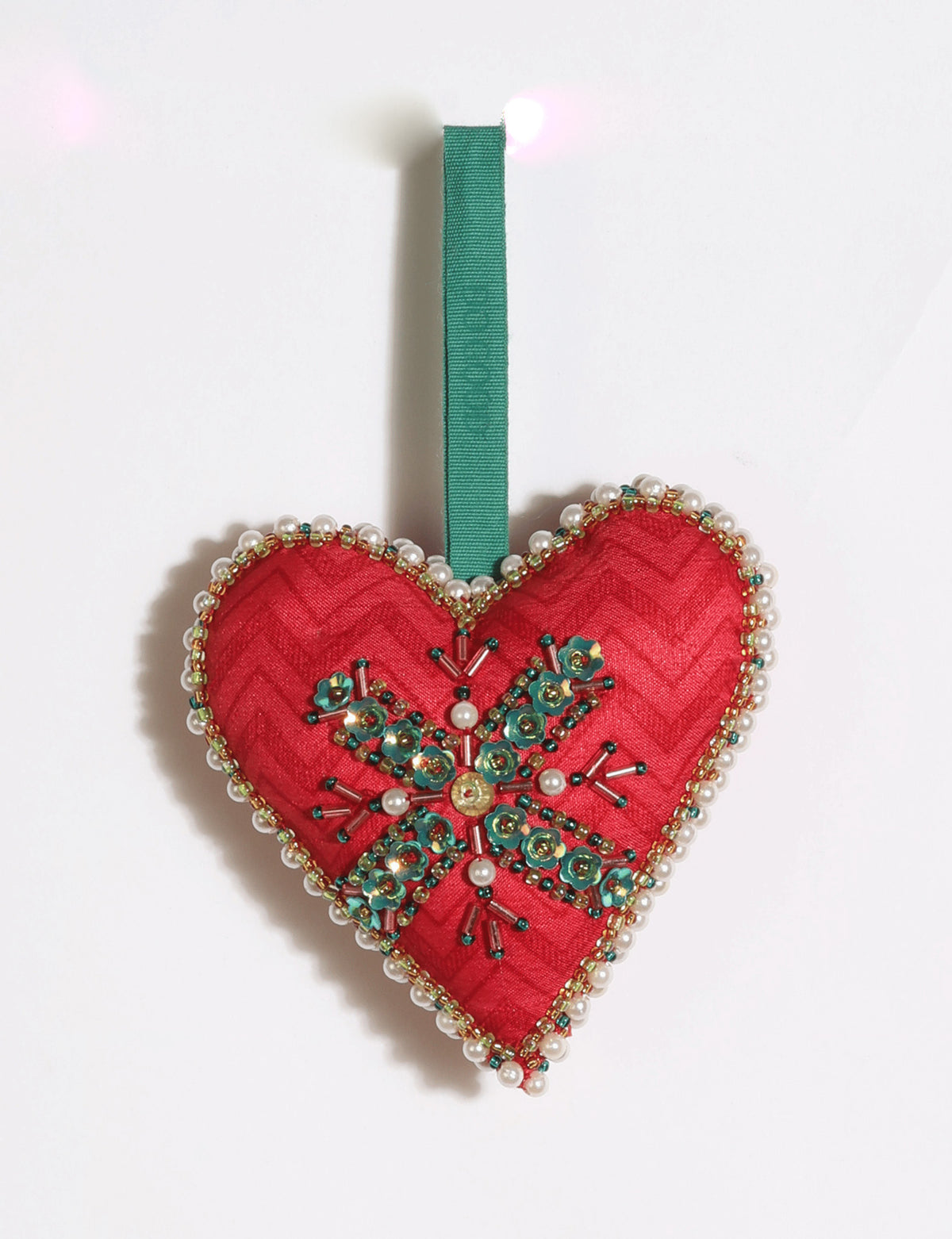 Cheer heart-shaped festive ornament made from vibrant upcycled saris with hand-embroidered Aari work, beads, sequins, and pearls.