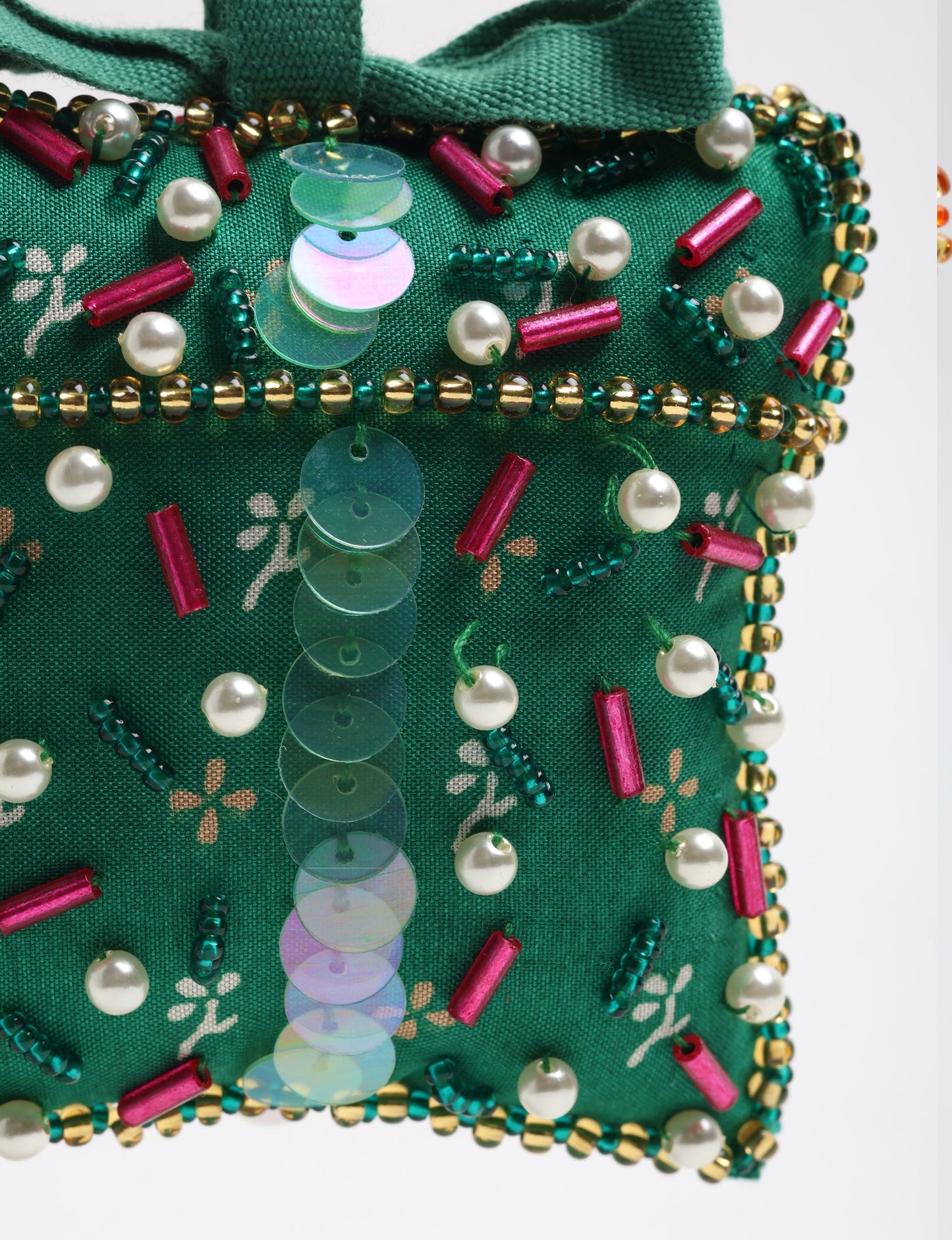 Upcycled bell-shaped Cheer Gift Ornament handmade from recycled sari fabric and decorated with pearls and sequins — an example of eco friendly fashion, recycled clothing, and circular fashion. A festive, earth-friendly decoration from Fair trade fashion and environmentally friendly clothing craftsmanship.