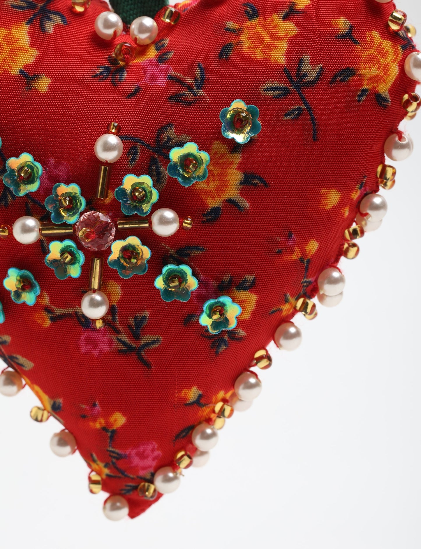 Cheer Heart Ornament made from recycled sari fabric, featuring pearl and bead embroidery. A handcrafted piece of upcycled women’s clothing art that embodies conscious clothing, natural textiles, and sustainable women’s fashion for an environmentally friendly holiday look.