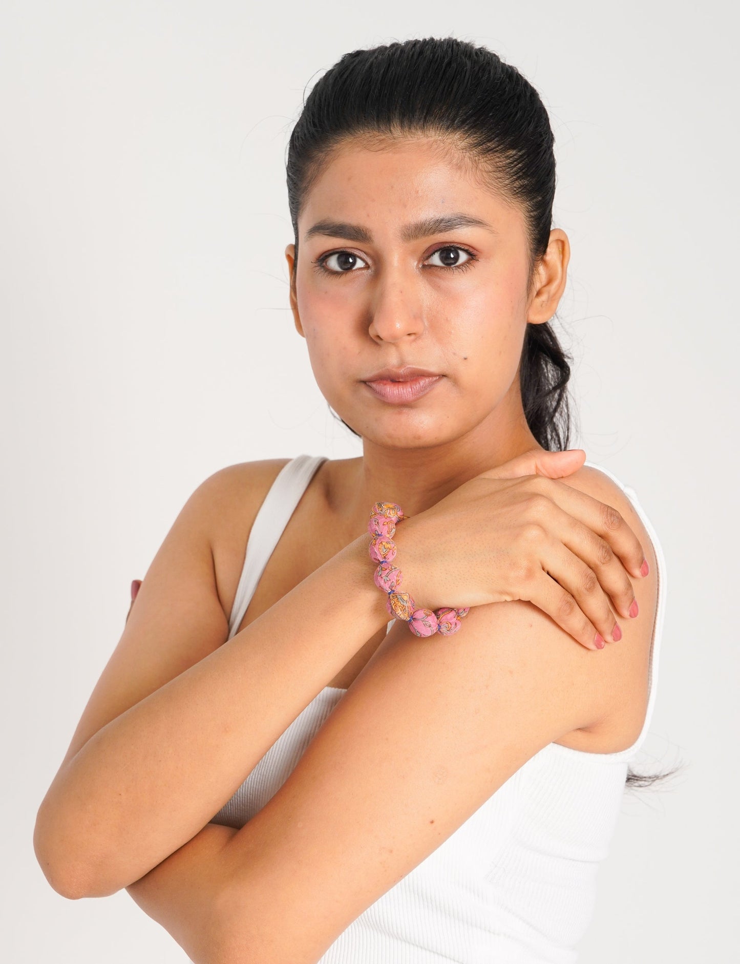 Eco friendly beaded knotted bracelet crafted from upcycled women’s clothing and repurposed sari fabrics, showcasing circular fashion and sustainable apparel.