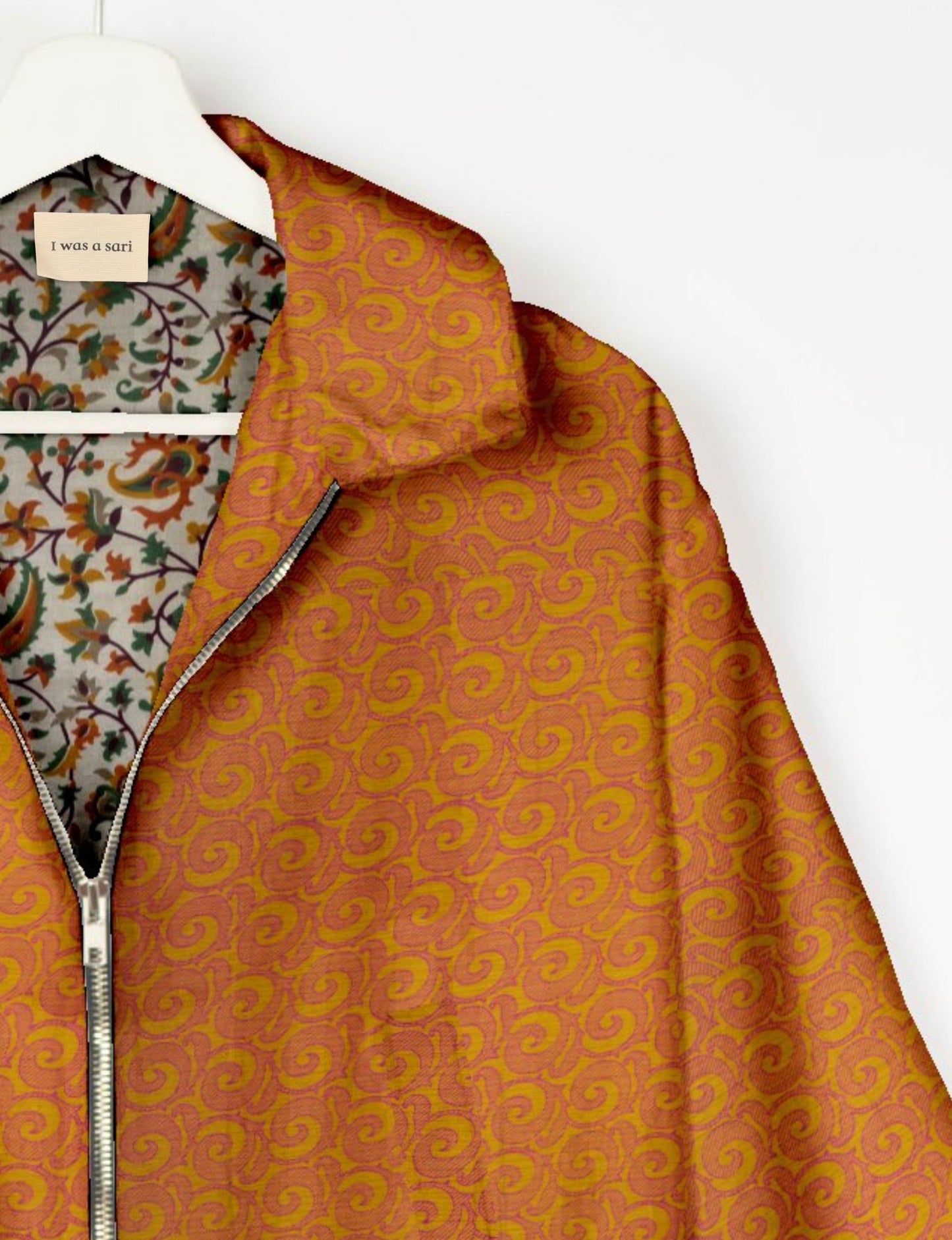 Upcycled Bomber Jacket made from recycled sari materials, featuring a cute cropped shape, elasticated hem and cuffs, and contrast sari print lining. Sustainable apparel promoting eco-friendly fashion and ethical clothing.