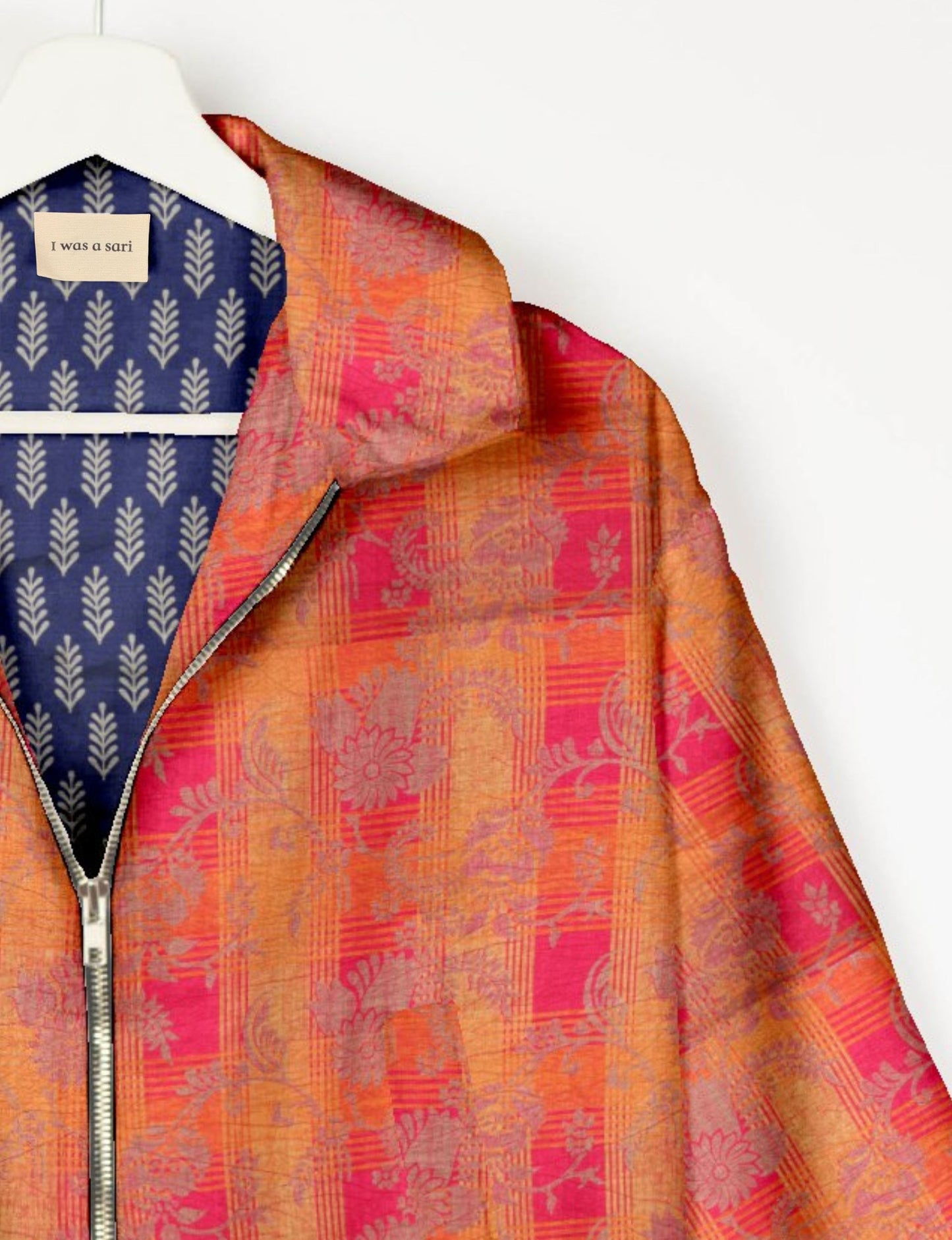 Upcycled Bomber Jacket made from recycled sari materials, featuring a cute cropped shape, elasticated hem and cuffs, and contrast sari print lining. Sustainable apparel promoting eco-friendly fashion and ethical clothing.