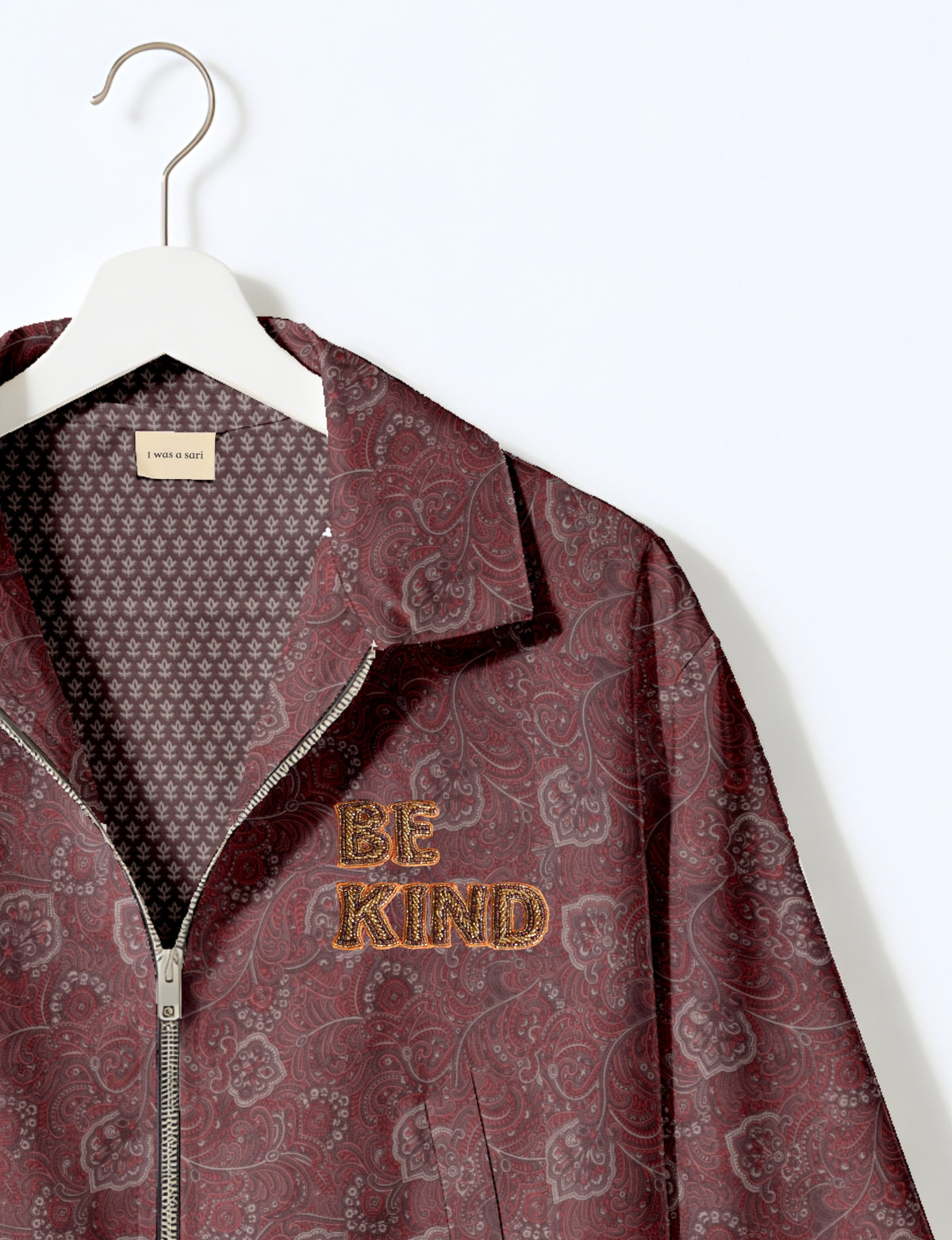BE KIND Bomber jacket made from upcycled sari fabric with handcrafted Aari embroidery by female artisans.