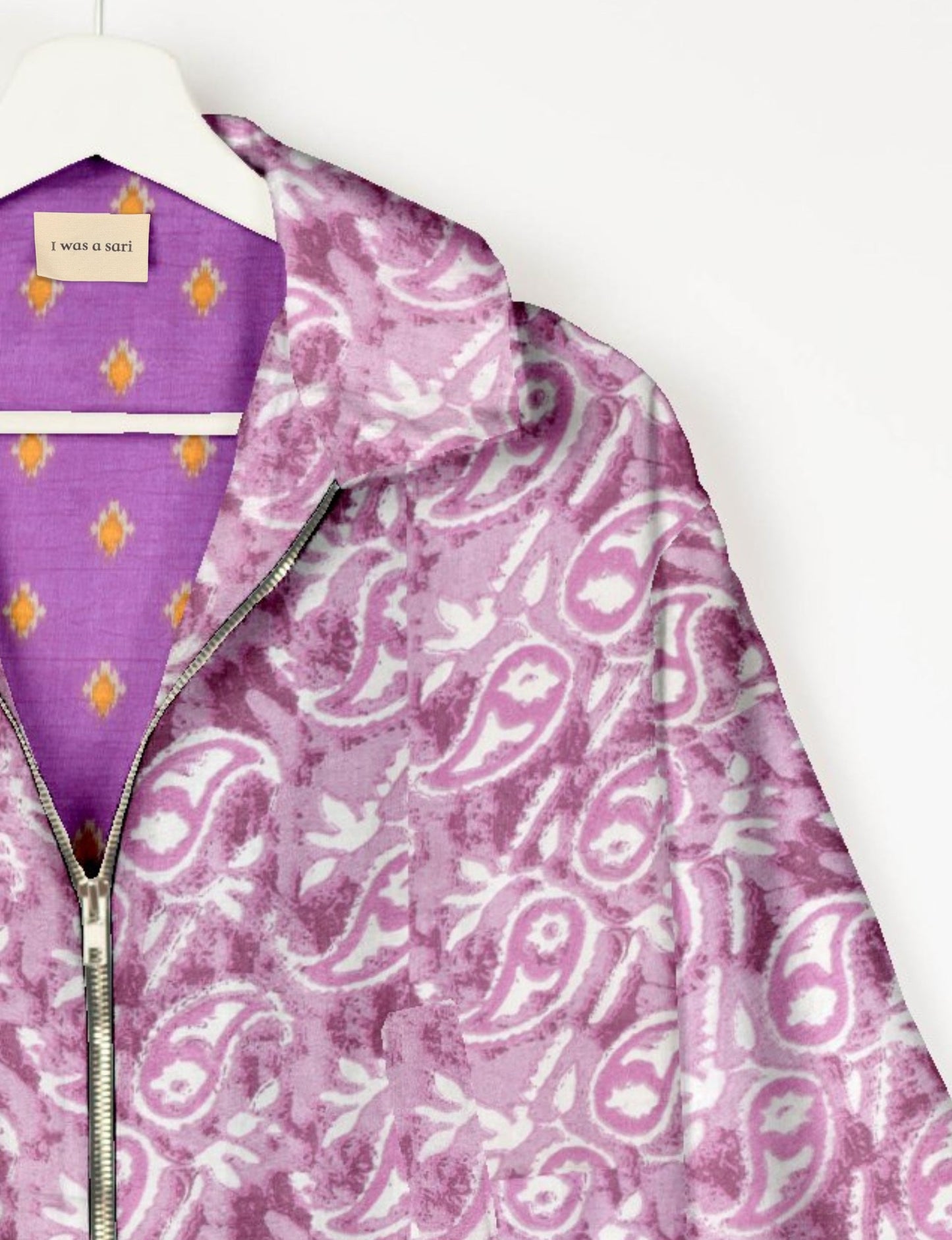 Upcycled Bomber Jacket made from recycled sari materials, featuring a cute cropped shape, elasticated hem and cuffs, and contrast sari print lining. Sustainable apparel promoting eco-friendly fashion and ethical clothing.