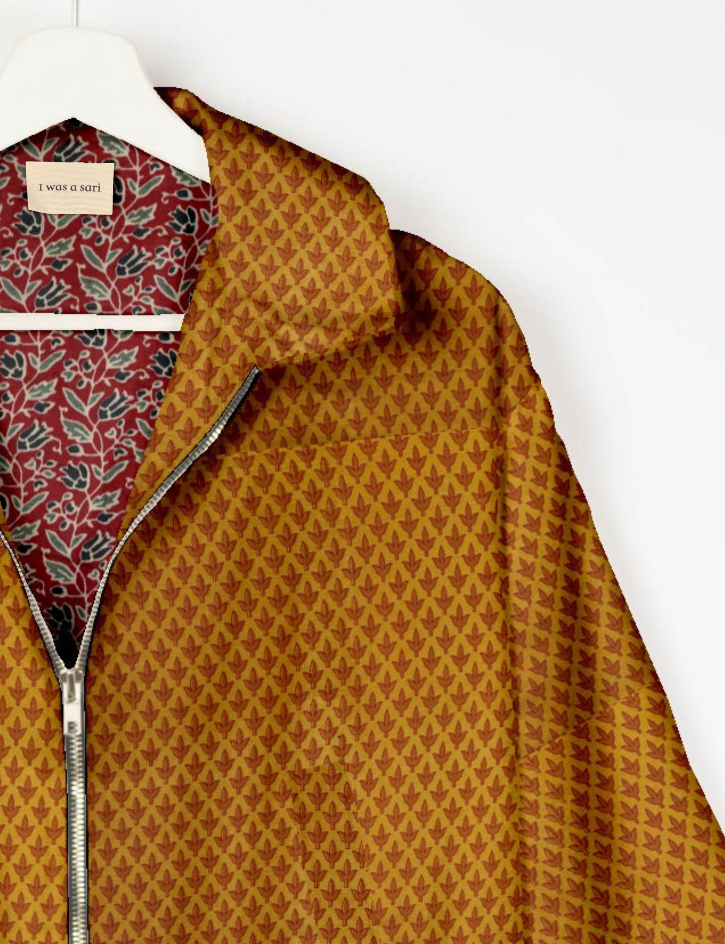 Upcycled Bomber Jacket made from recycled sari materials, featuring a cute cropped shape, elasticated hem and cuffs, and contrast sari print lining. Sustainable apparel promoting eco-friendly fashion and ethical clothing.