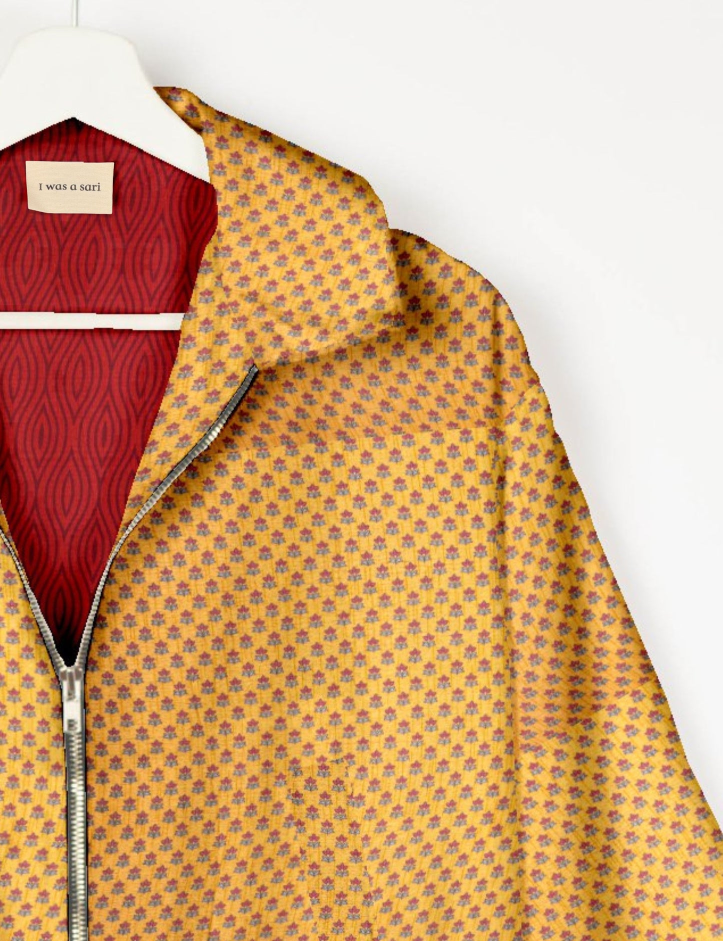 Upcycled Bomber Jacket made from recycled sari materials, featuring a cute cropped shape, elasticated hem and cuffs, and contrast sari print lining. Sustainable apparel promoting eco-friendly fashion and ethical clothing.