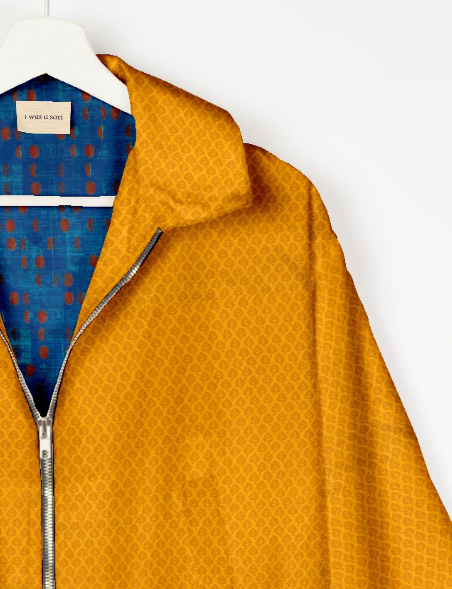 Upcycled Bomber Jacket made from recycled sari materials, featuring a cute cropped shape, elasticated hem and cuffs, and contrast sari print lining. Sustainable apparel promoting eco-friendly fashion and ethical clothing.