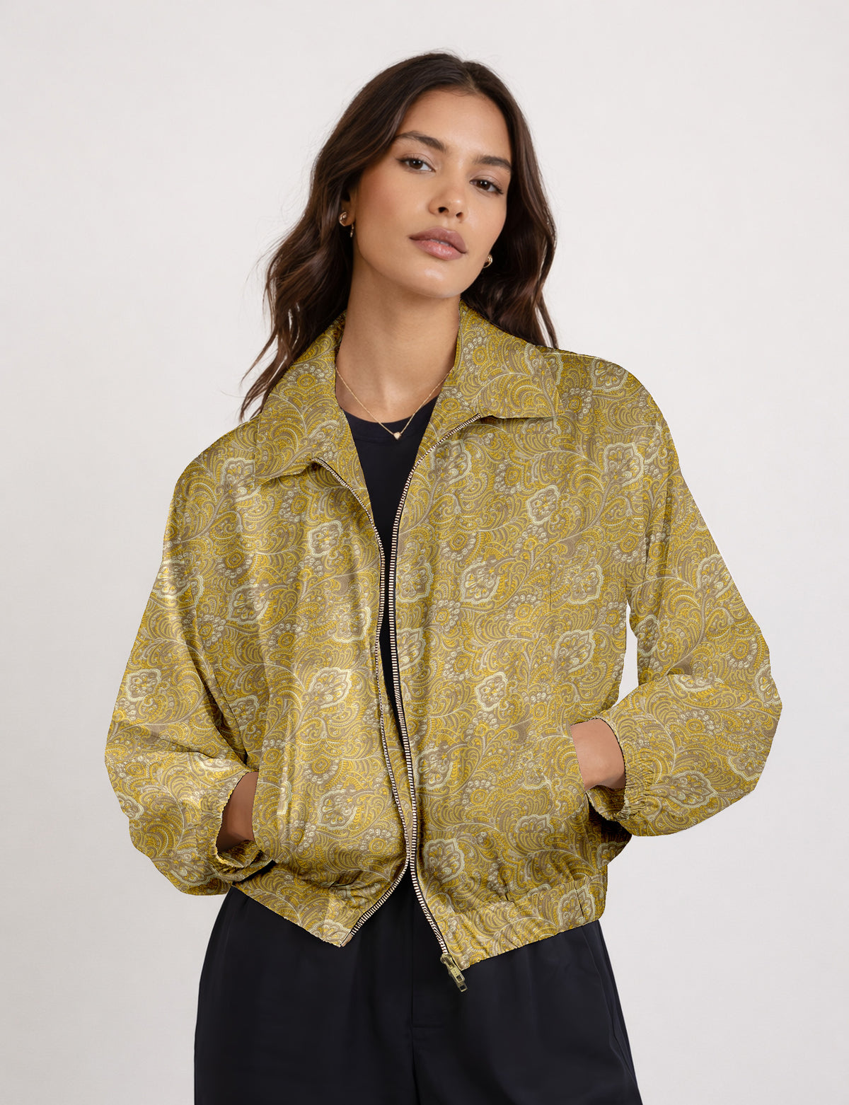 Woman wearing a yellow floral bomber jacket with front zipper, elastic cuffs, and side pockets, shown from front view