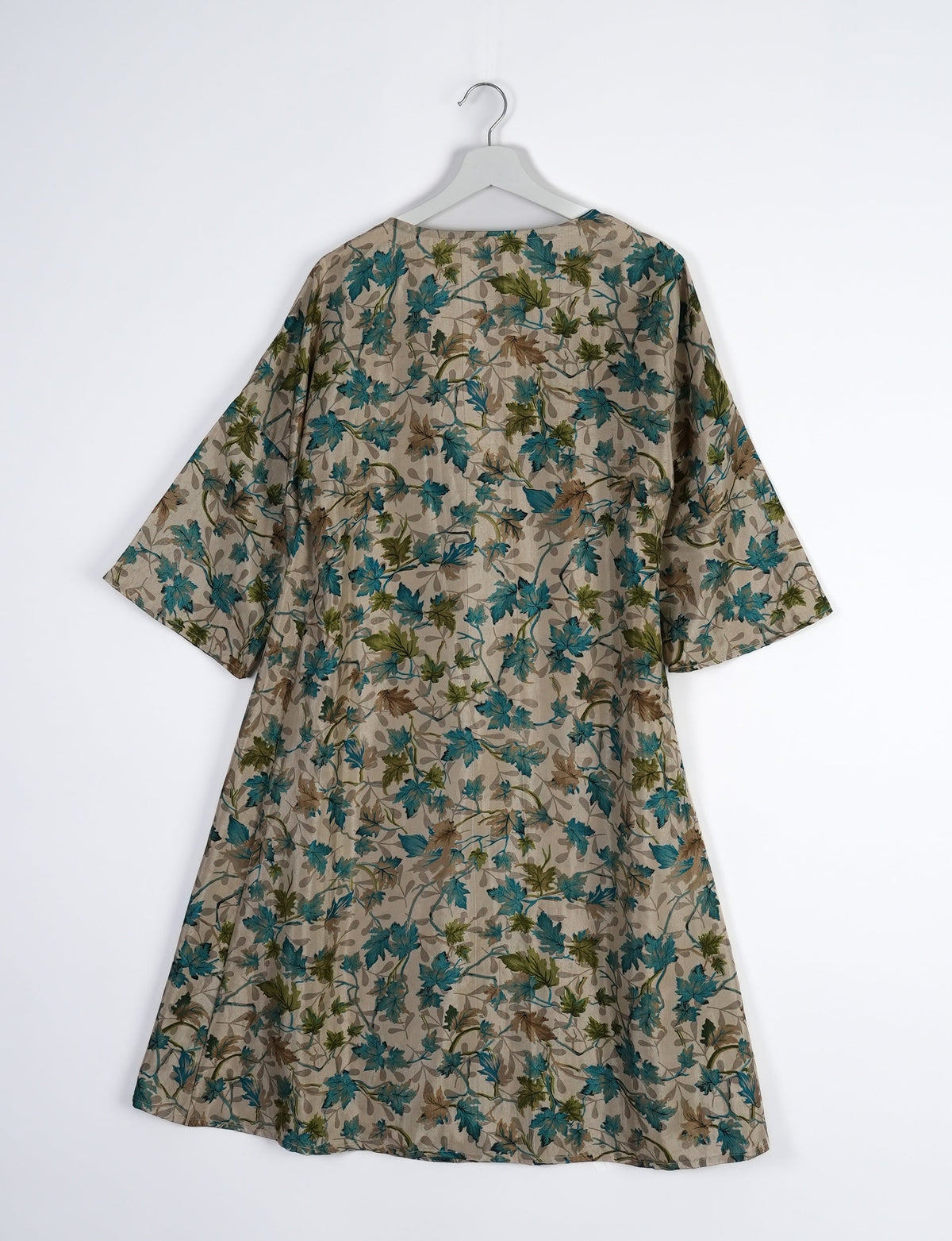 Elevate your style with our Sunset Coat, a shin-length wrap featuring a deep V-neck, wide flared 3/4 sleeves, and side tie with thread tassels. Embrace ethical and sustainable fashion with this zero waste, upcycled garment. A perfect blend of elegance and whimsy for conscious clothing enthusiasts.