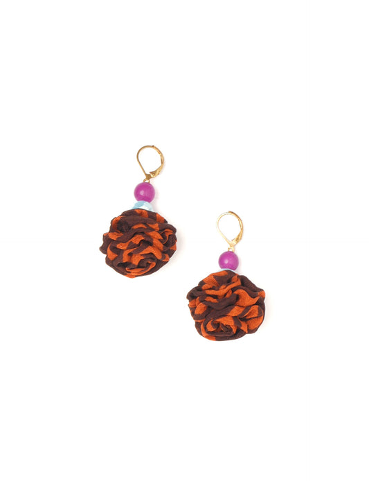 Elevate your style with our Ruffle Earrings, adorned with unique ruffle ball florets crafted from upcycled Indian saris using the traditional Aari embroidery technique. These sustainable earrings feature two glass beads and nickel-free, hypoallergenic metal hooks. Embrace ethical and green fashion with these statement pieces.