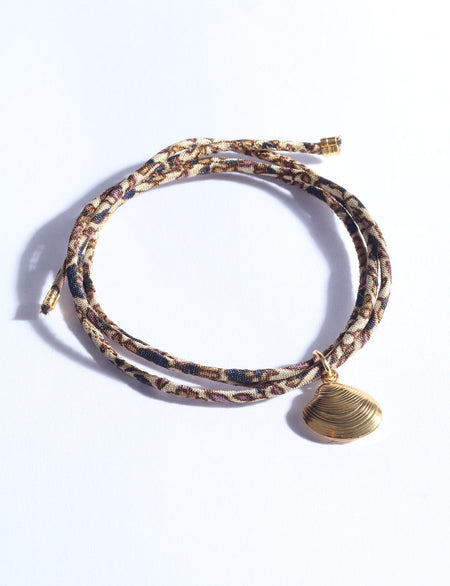 Cord bracelet with charm shell