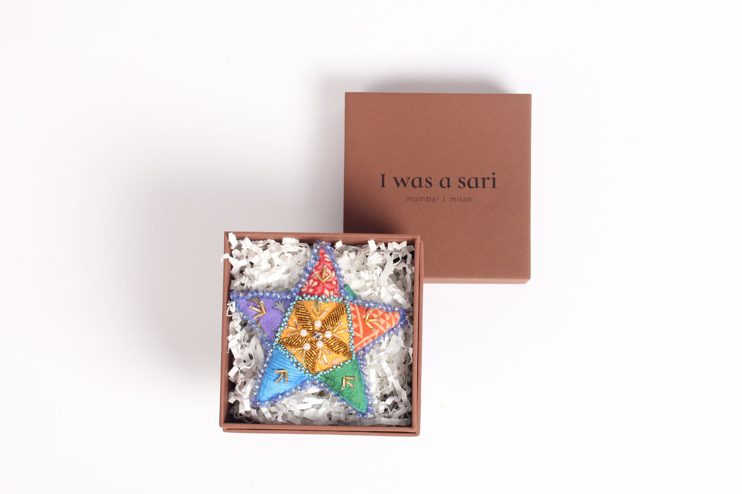 Colorful star-shaped Artisans Christmas Ornament made from upcycled fabric, symbolizing joy and hope. A sustainable fashion item promoting eco-friendly, zero-waste clothing and ethical fashion practices.