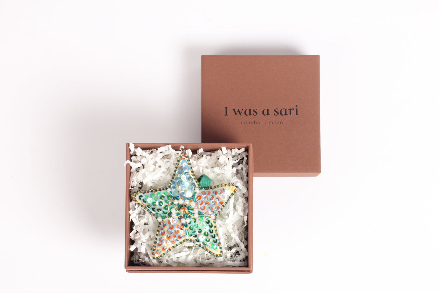 Star-shaped Artisans Christmas Ornament with web embroidery, crafted from upcycled materials. A symbol of strength and sustainability, promoting ethical fashion, recycled clothing, and eco-friendly fashion ideals.