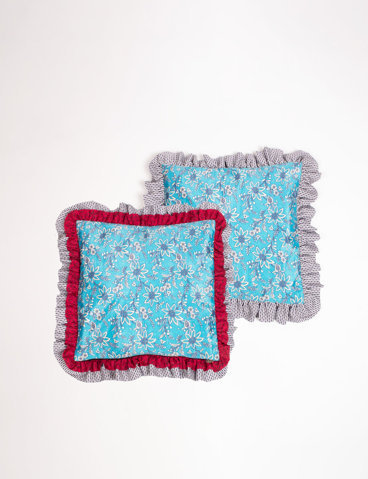 Set of 2 blue floral cushion covers with double frill edges, one with red inner frill and one with striped inner frill
