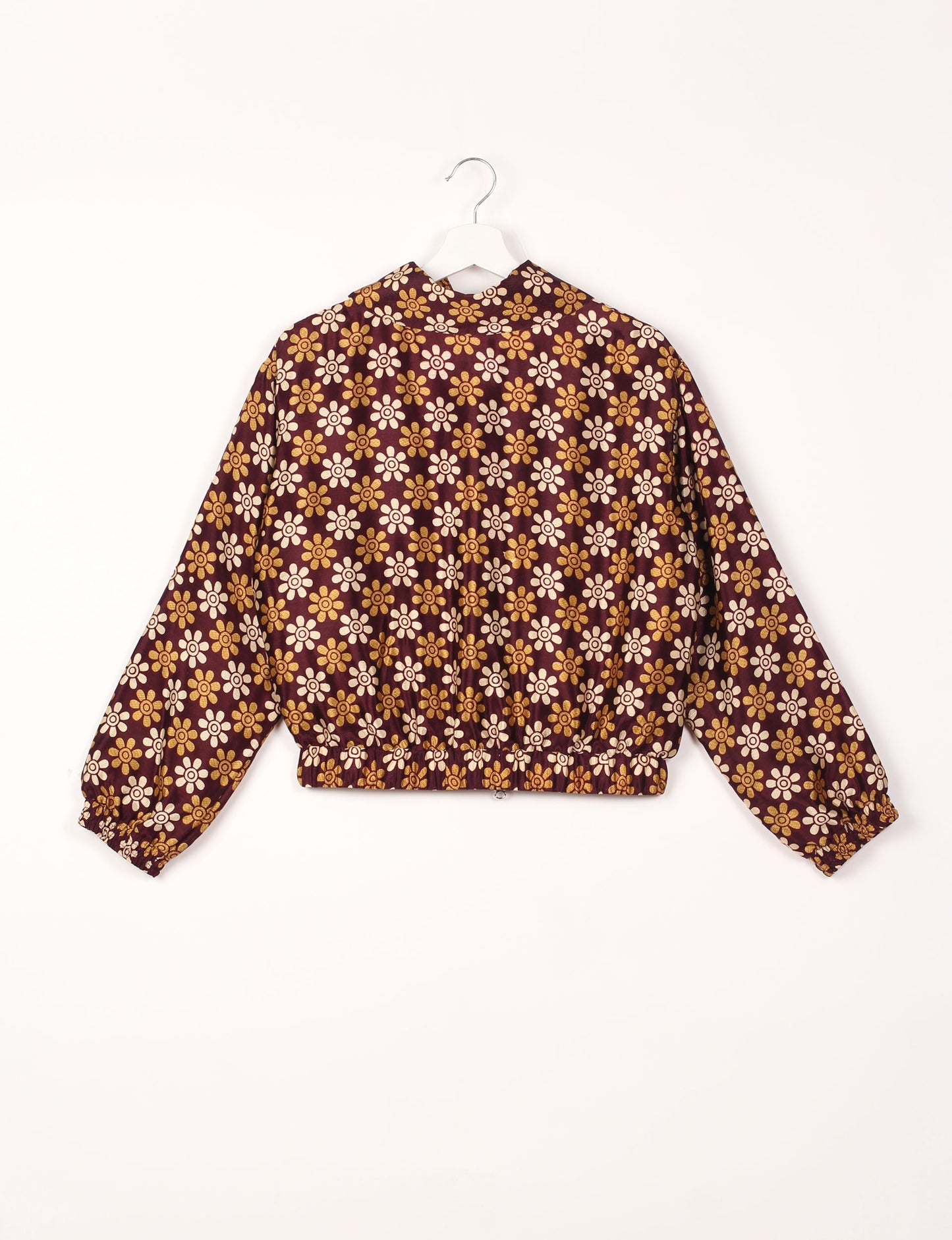 Stylish BOMBER JACKET, an upcycled clothing masterpiece with a cute cropped shape, elasticated details, and detachable metallic zipper. Contrast sari print lining adds a unique touch. Explore sustainable and eco-friendly fashion.