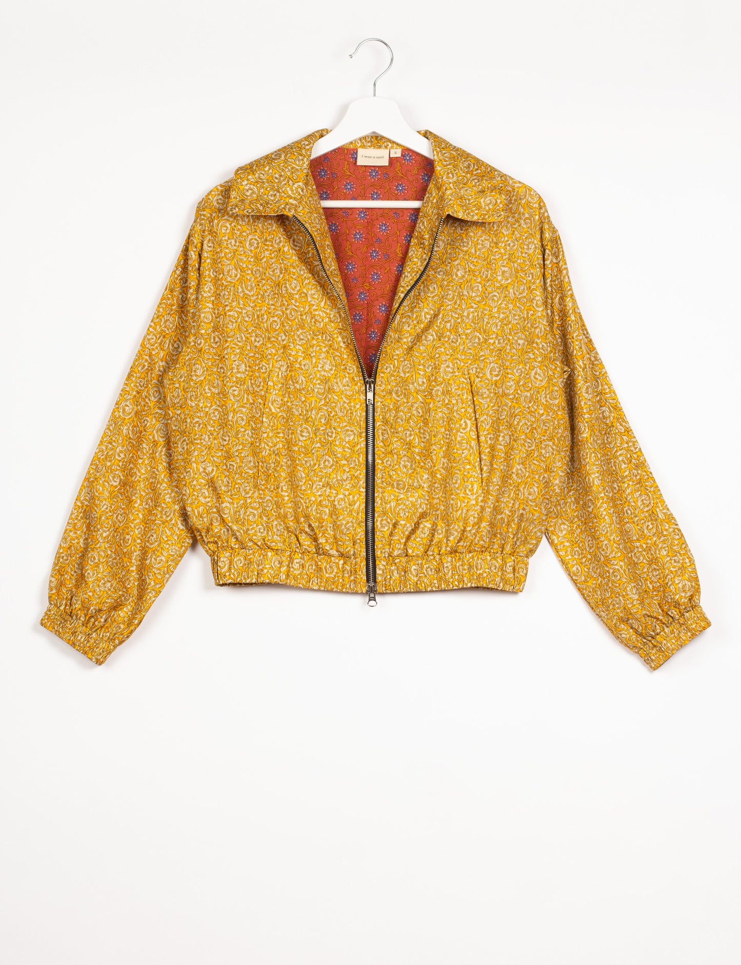 Stylish BOMBER JACKET, an upcycled clothing masterpiece with a cute cropped shape, elasticated details, and detachable metallic zipper. Contrast sari print lining adds a unique touch. Explore sustainable and eco-friendly fashion.