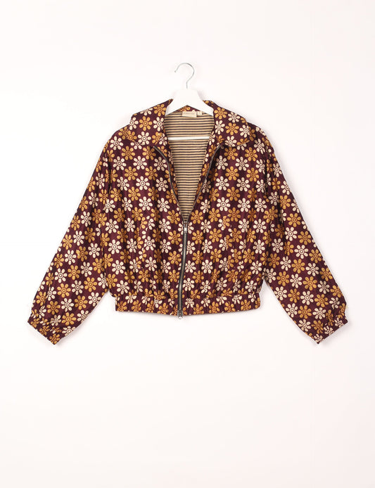 Stylish BOMBER JACKET, an upcycled clothing masterpiece with a cute cropped shape, elasticated details, and detachable metallic zipper. Contrast sari print lining adds a unique touch. Explore sustainable and eco-friendly fashion.